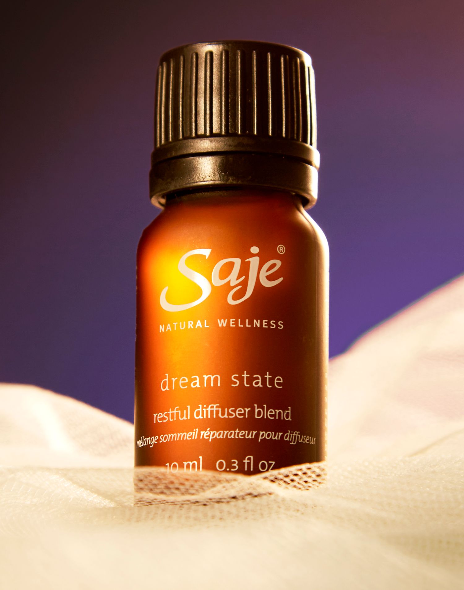 Saje Dream State essential oil blend bottle with purple gradient background.