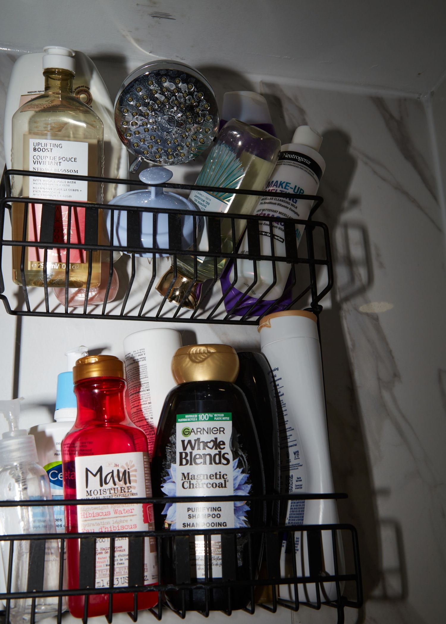 A bathroom shelf organizer filled with various personal care products and bottles.