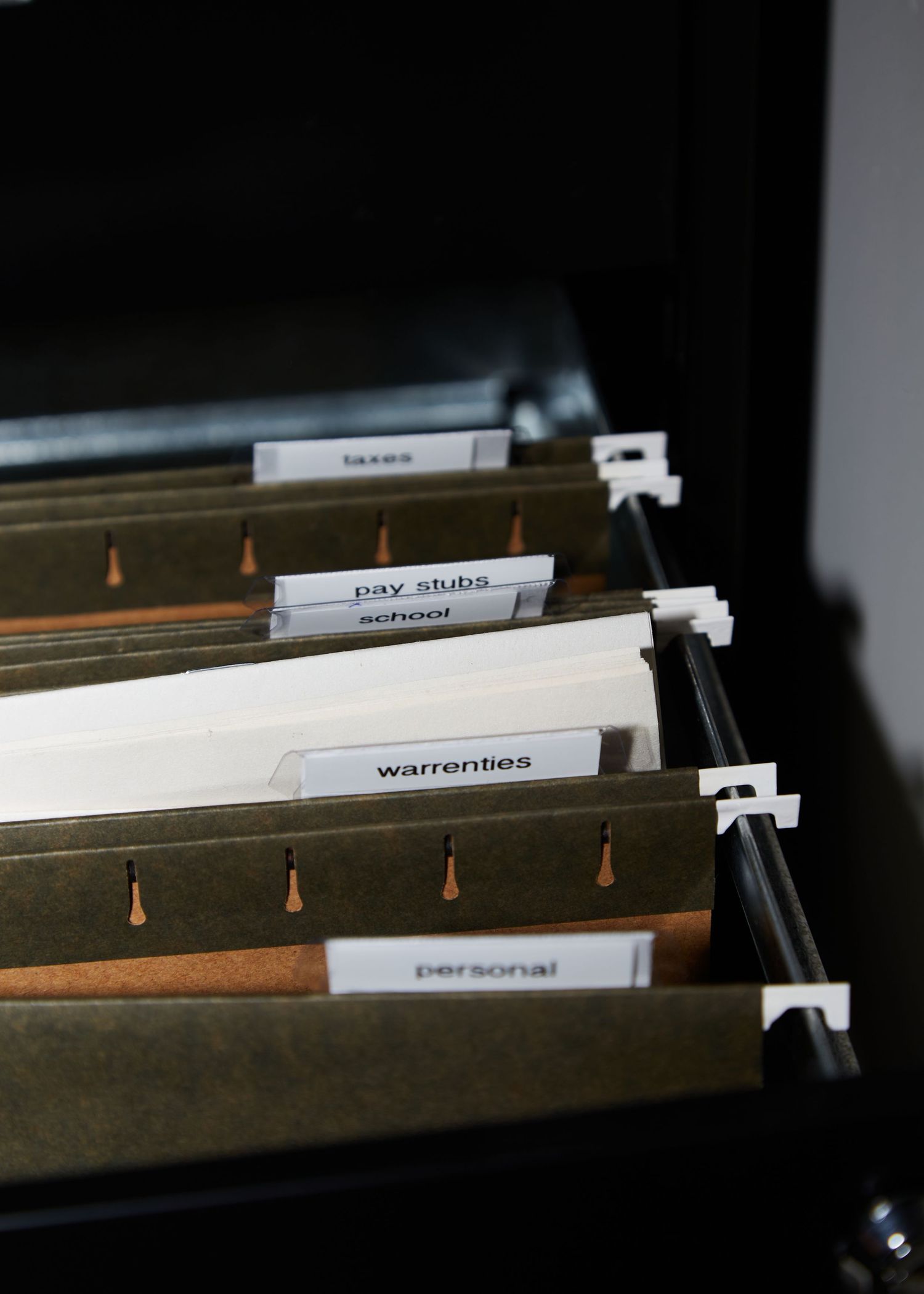 Filing cabinet with labeled hanging folders organized alphabetically.