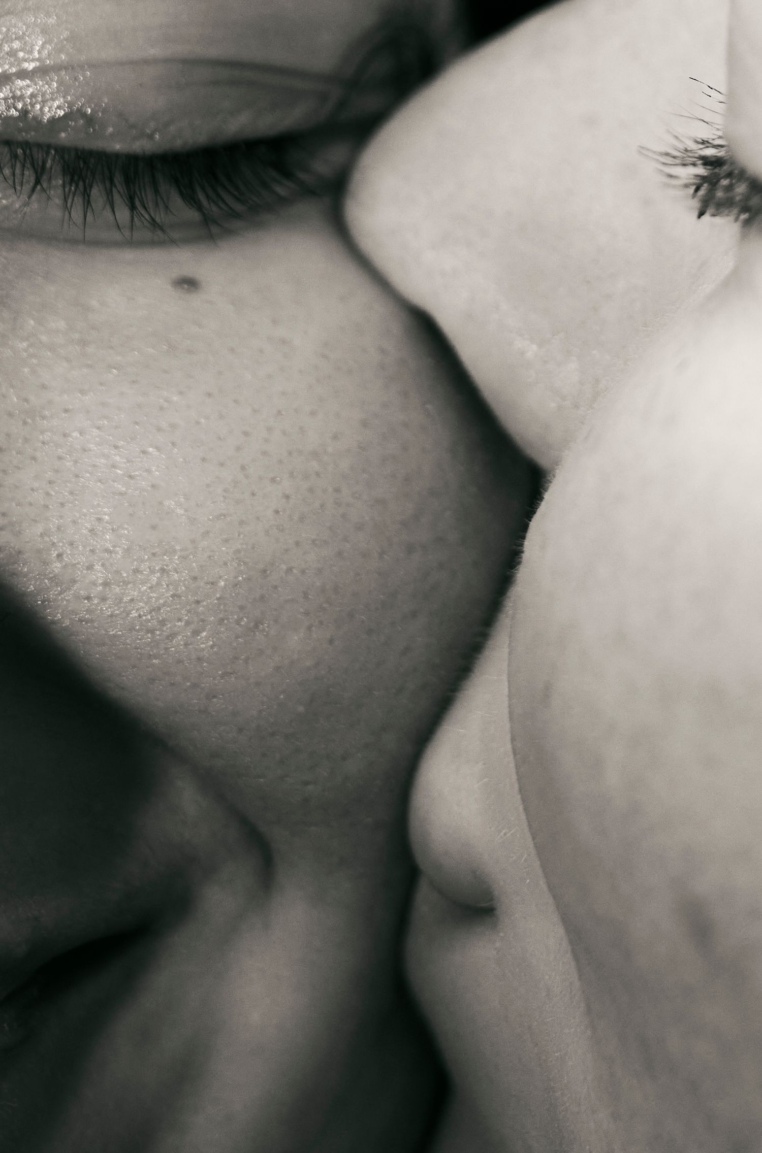 Extreme close-up black and white photo showing facial features in soft focus.