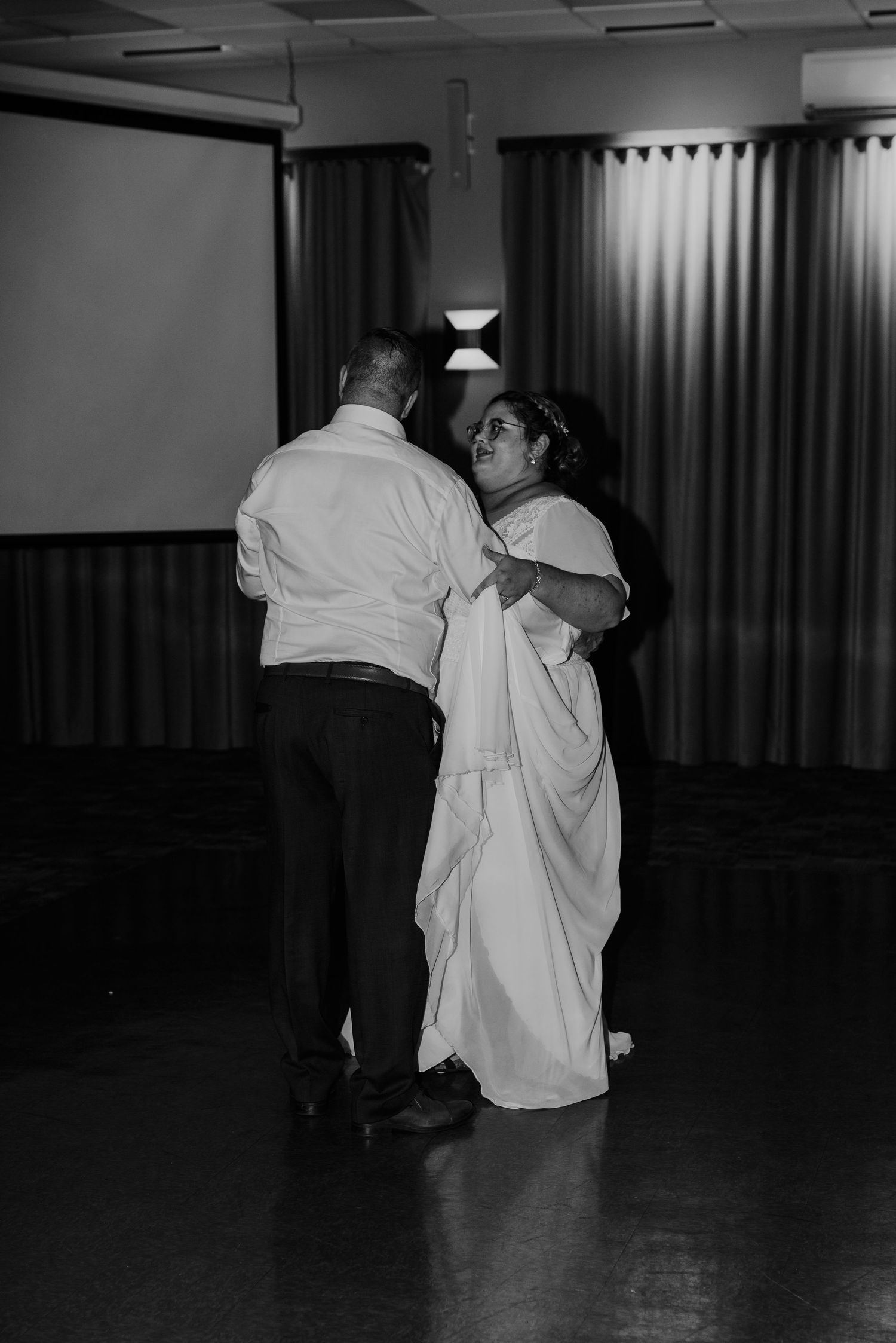 Couple sharing an intimate slow dance at their wedding reception.
