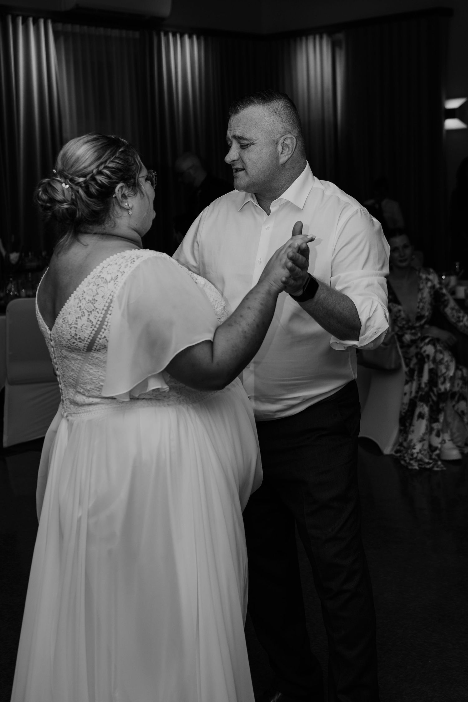 Couple dancing together during their wedding reception celebration.