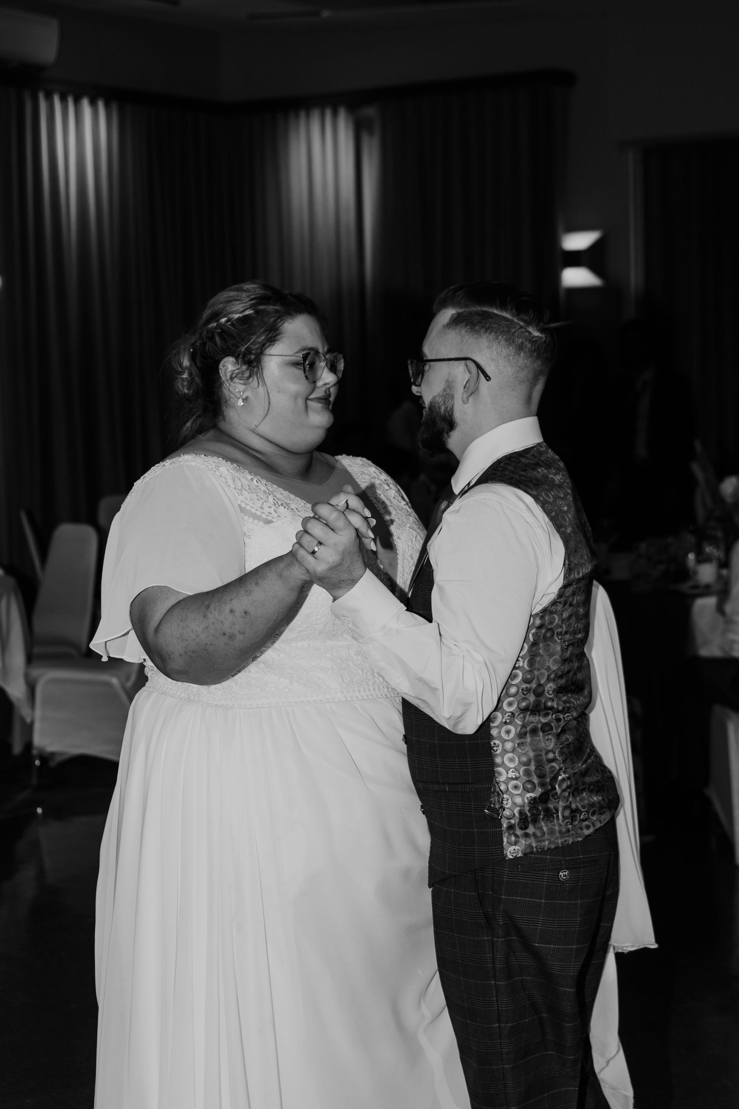 Couple sharing a romantic dance moment at their wedding celebration.