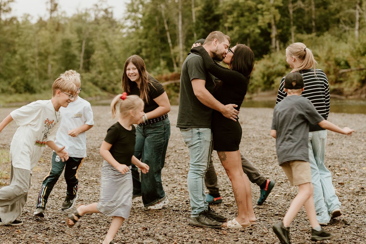 A sequence of candid moments showing people walking and playing together on a rocky beach in natural lighting.