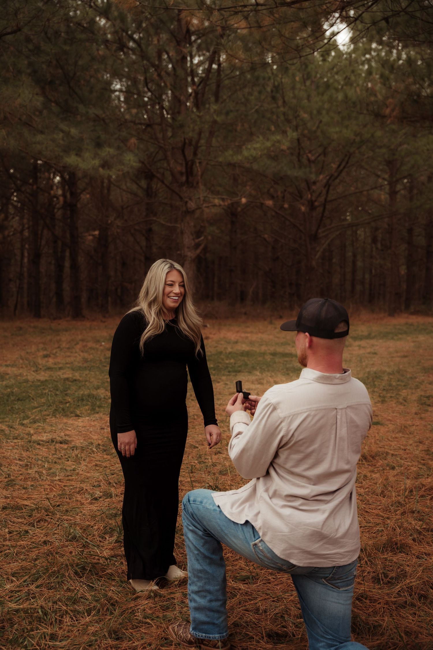Surprise proposal moment unfolds in sequence across autumn forest setting.