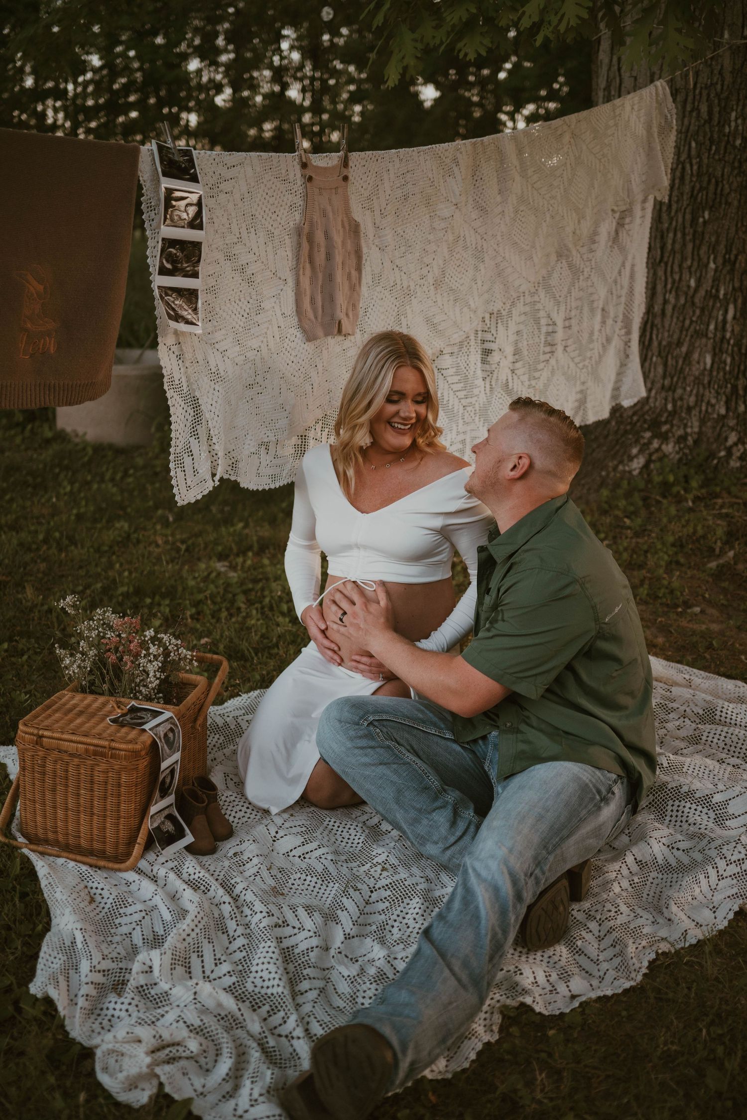 A vintage-inspired maternity session with lace decorations and a rustic picnic setting.