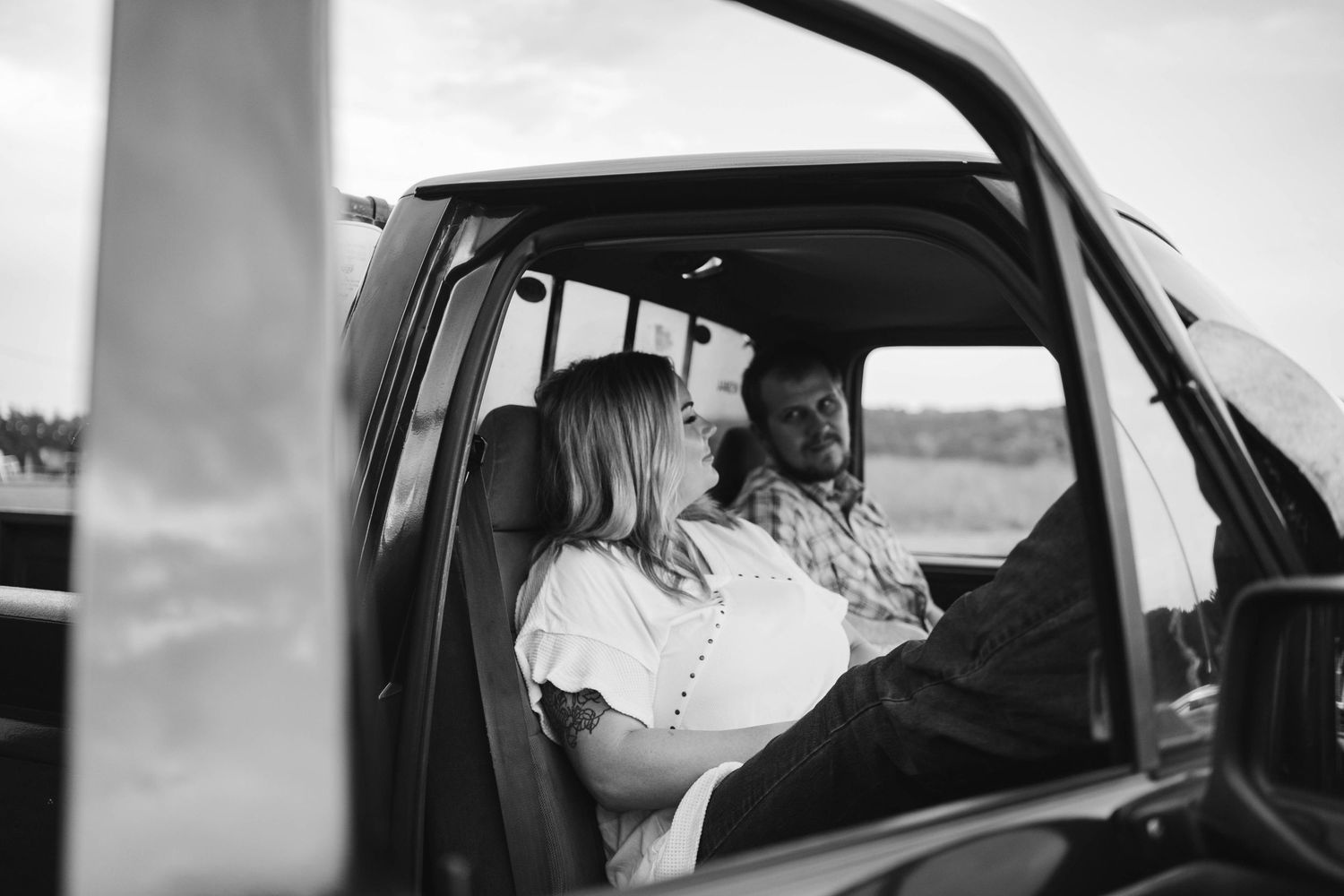 Black and white photo of people inside a vehicle.
