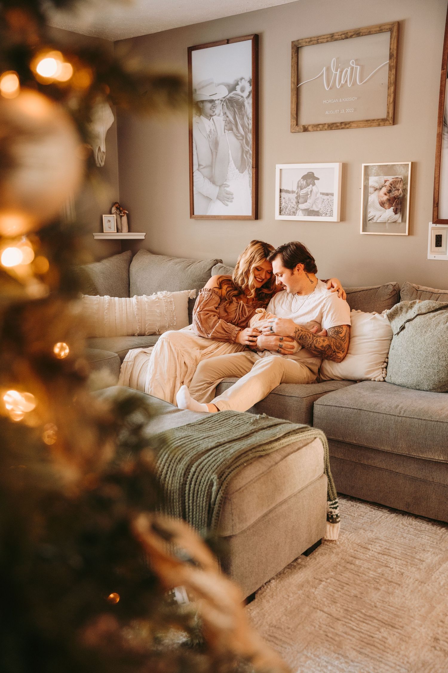 Cozy lifestyle photos of a couple relaxing together on a gray couch in a warmly lit living room.