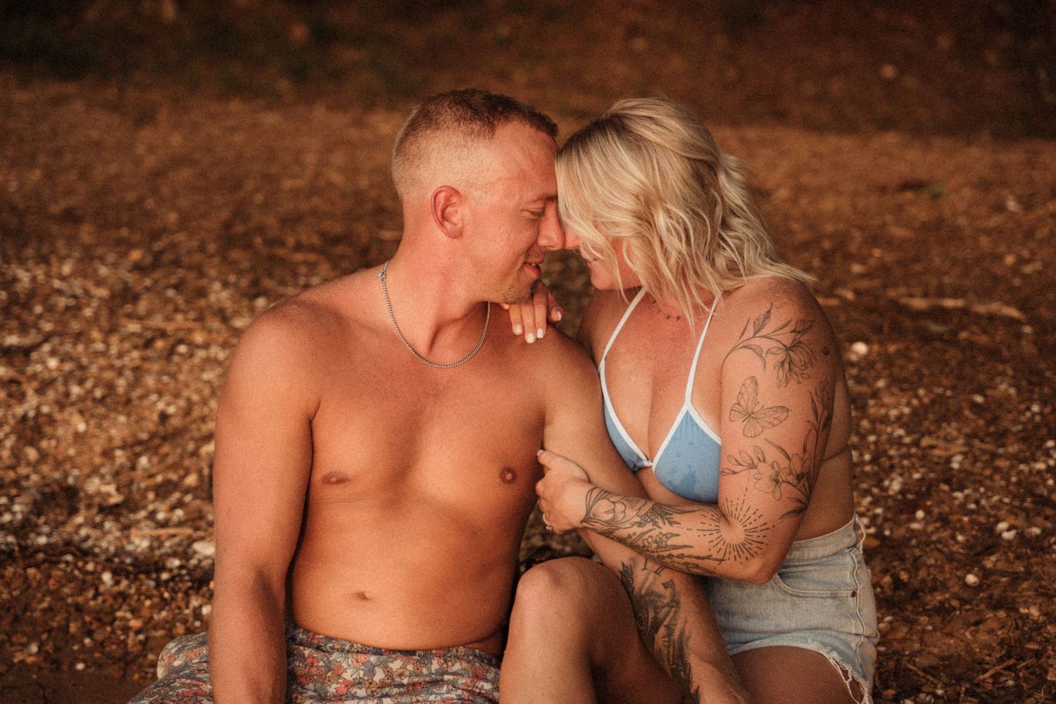 A romantic sunset moment captured on a beach with warm lighting.