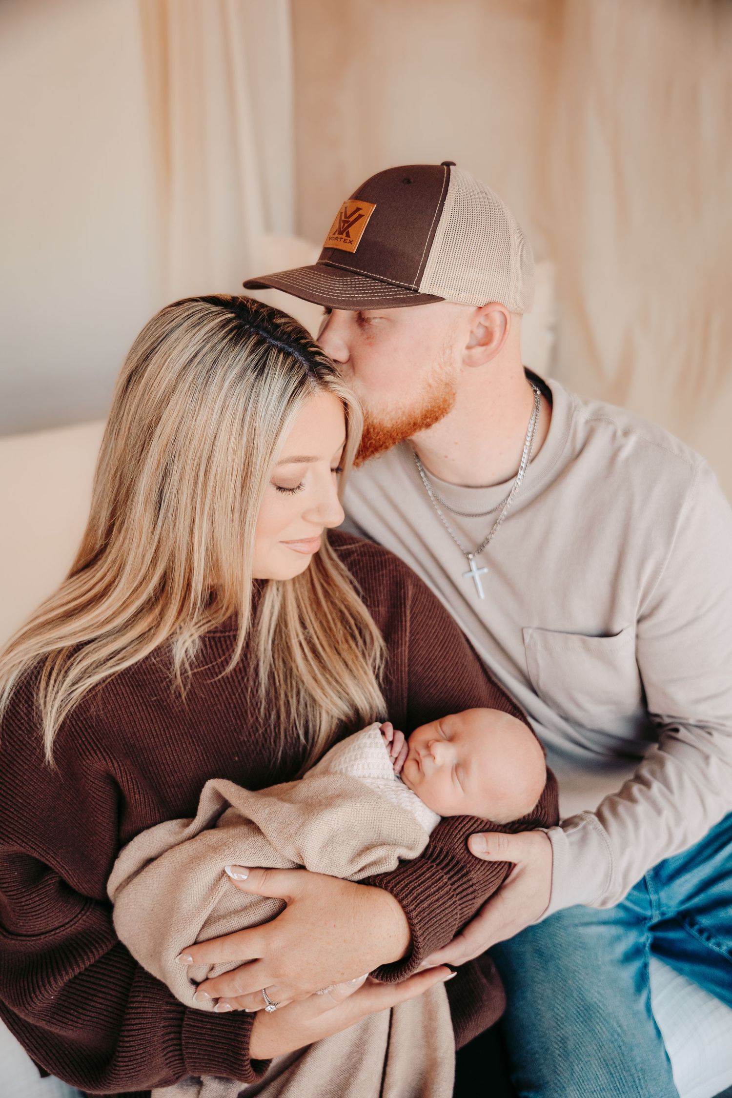 Intimate indoor lifestyle portrait session on couch in warm neutral tones.