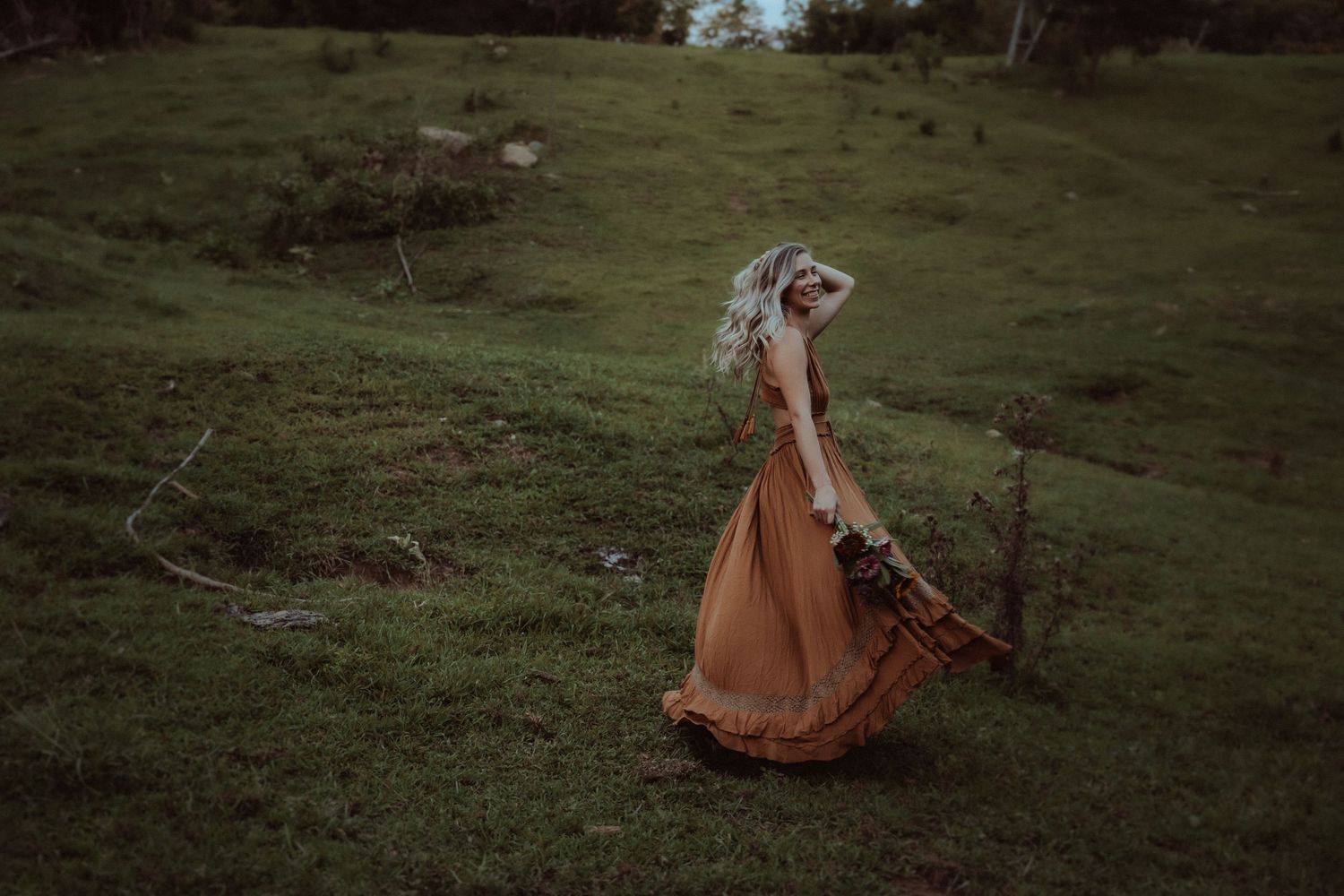 A flowing brown dress creates movement in an artistic outdoor photo sequence.