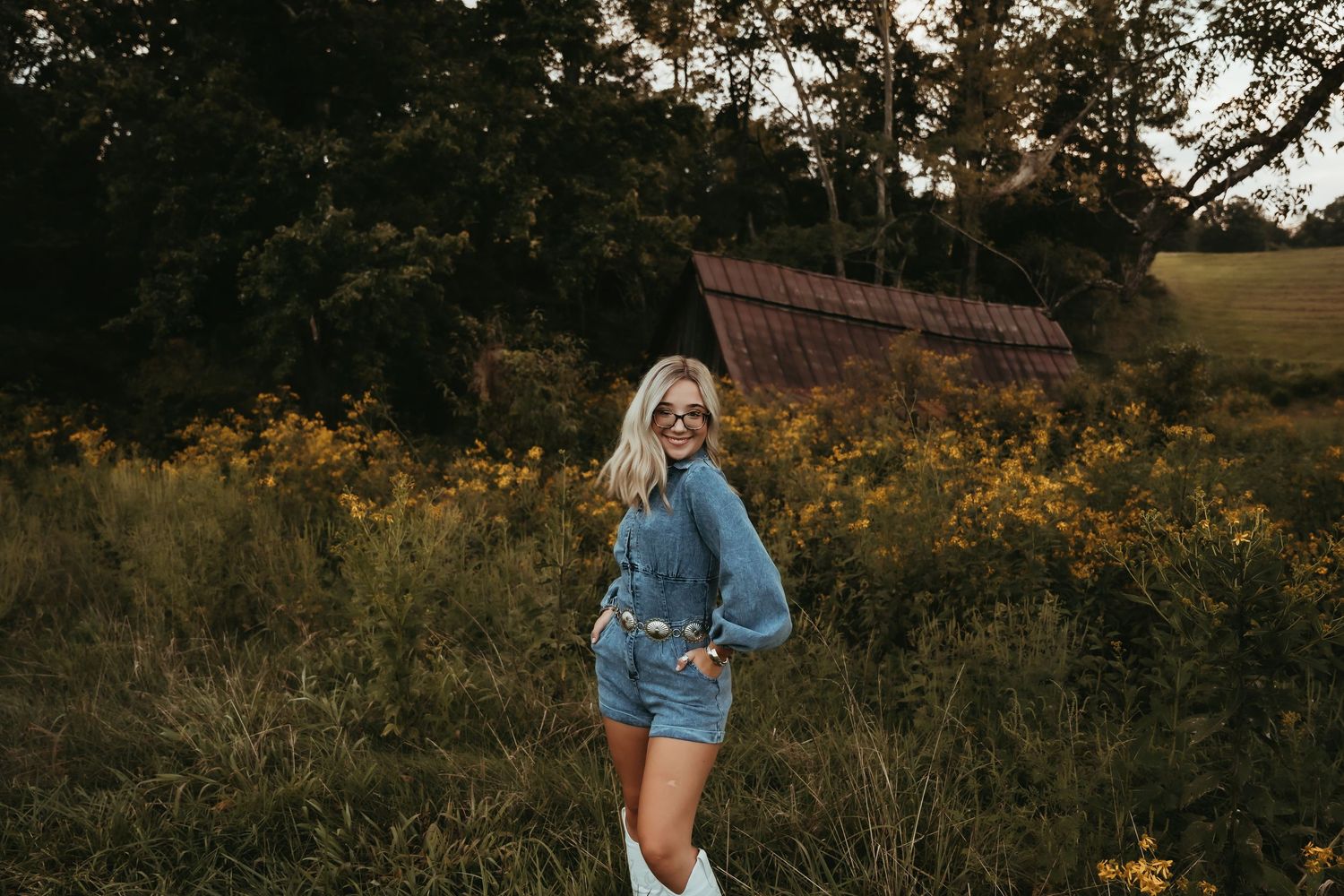 Rustic outdoor portrait session with denim fashion against autumn foliage.