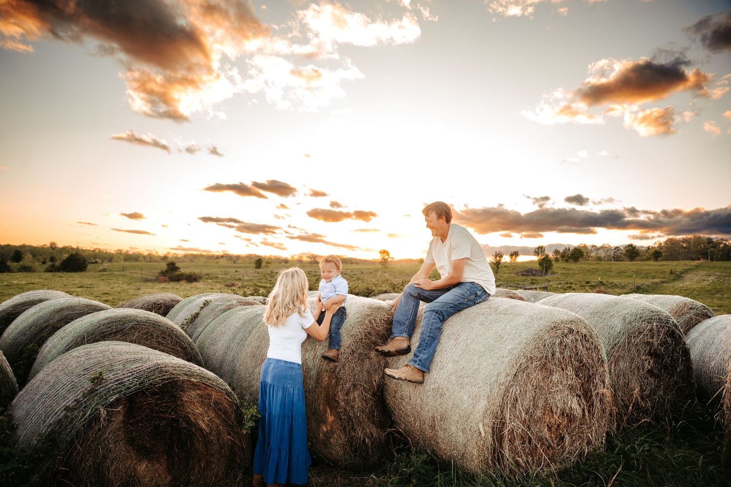 Artistic sunset photography with hay bales in a rural field.