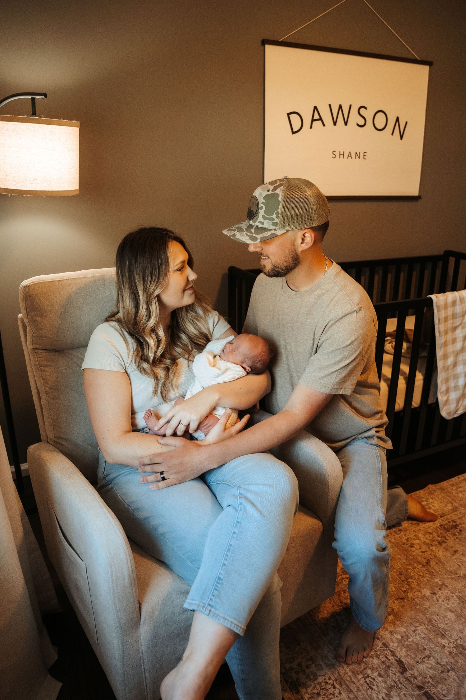 Cozy family portrait session in living room with modern decor and natural moments.