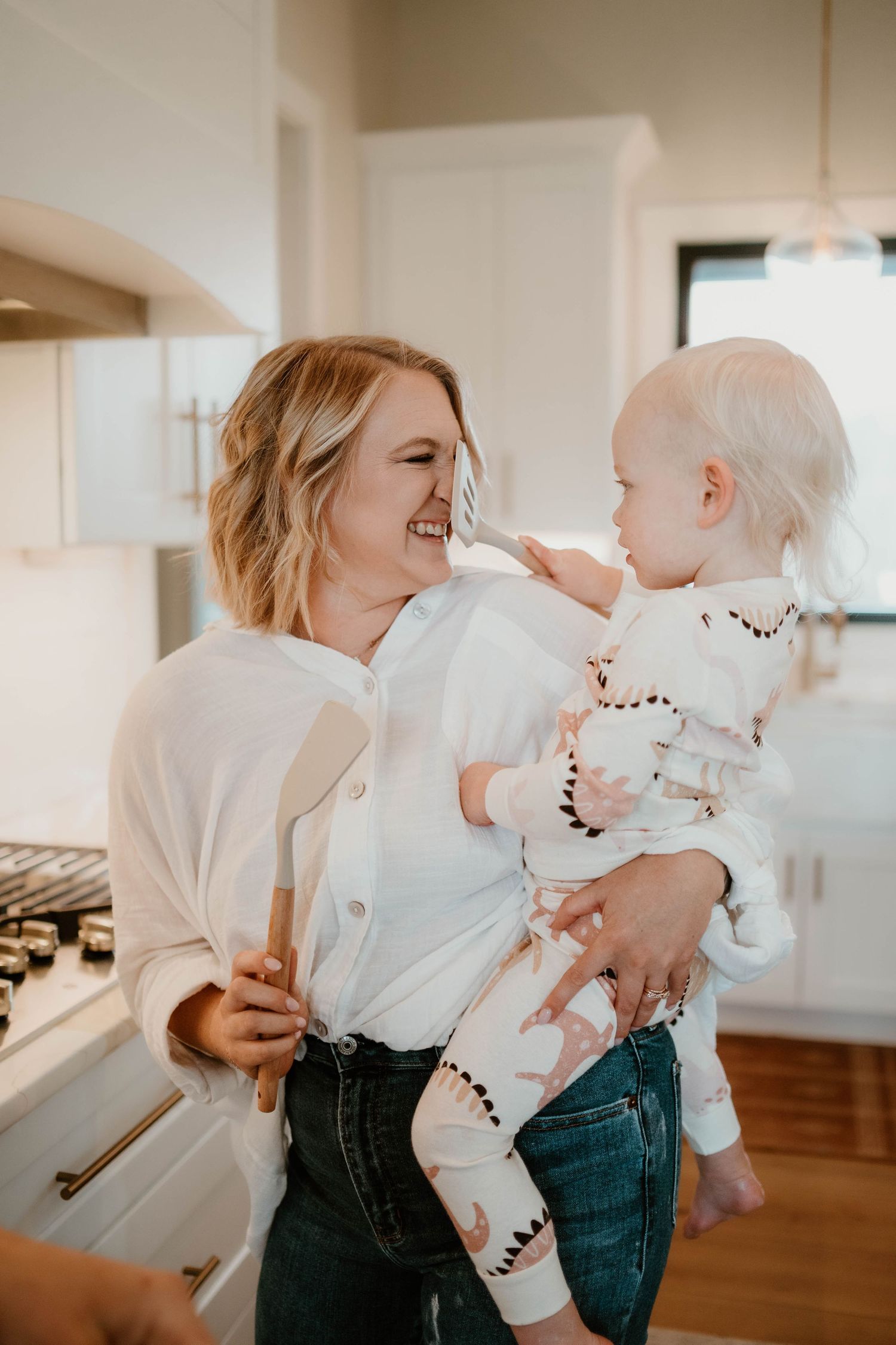Candid moments of family laughter and joy in a bright modern kitchen.