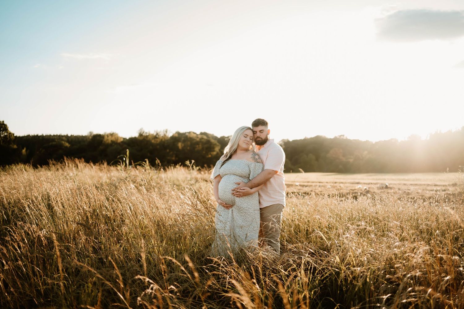 A romantic sunset photoshoot in a golden wheat field with soft lighting and natural scenery.
