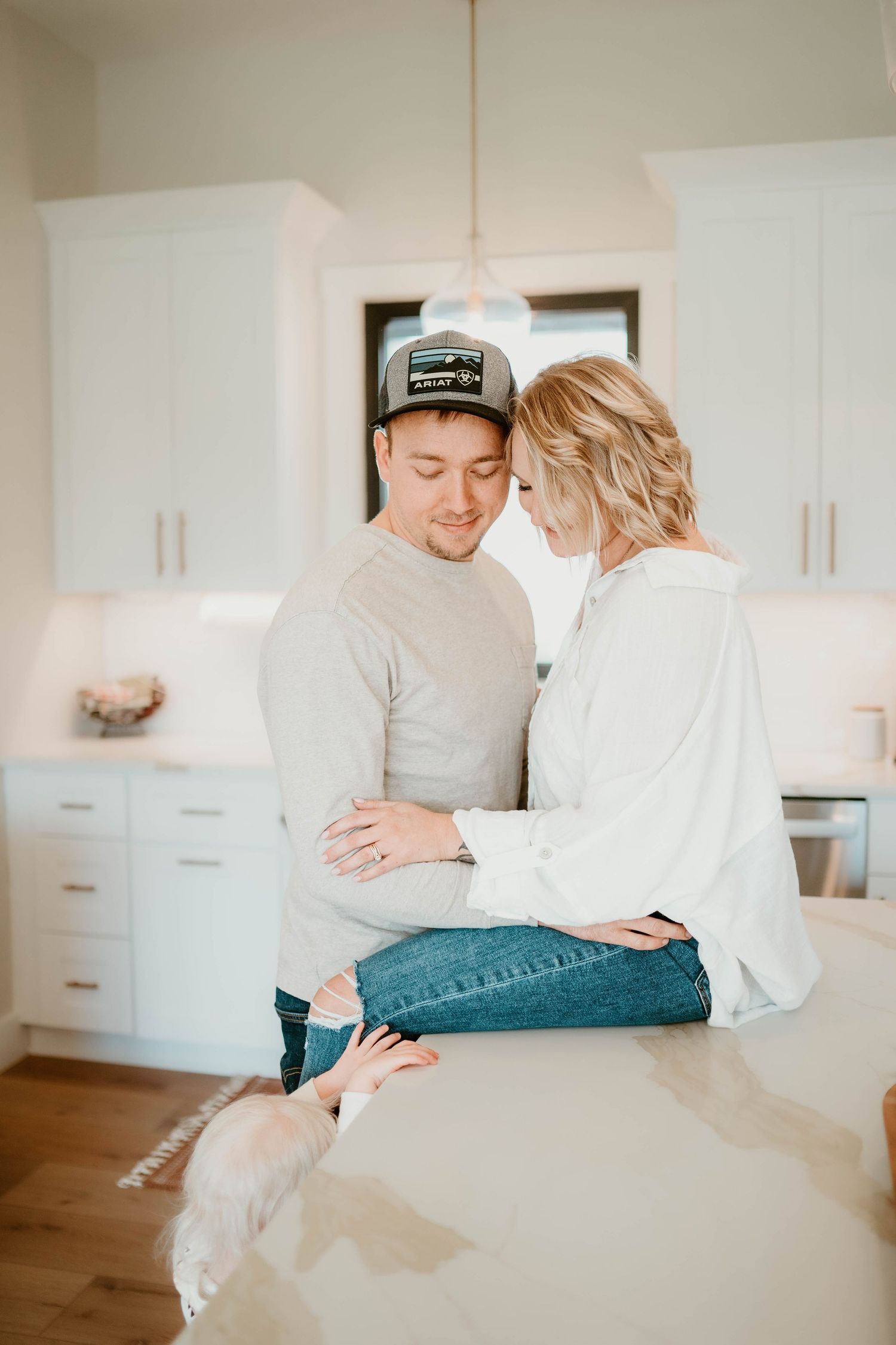 Intimate family moments shared on a couch in a modern white interior.