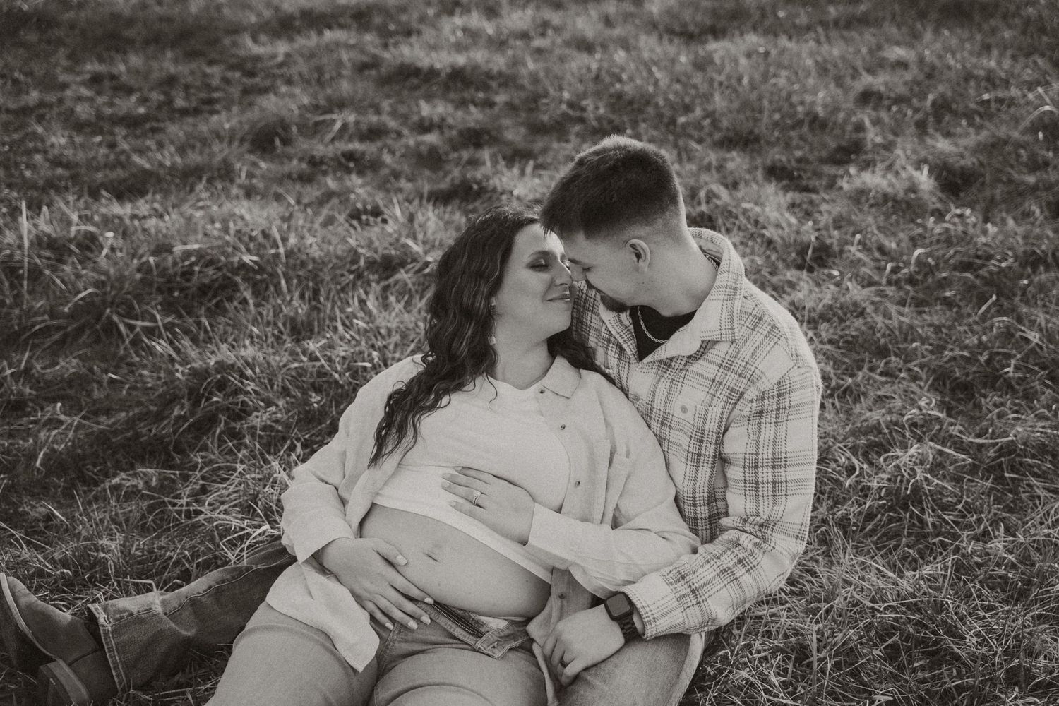 Romantic couple's photoshoot in rustic outdoor setting.