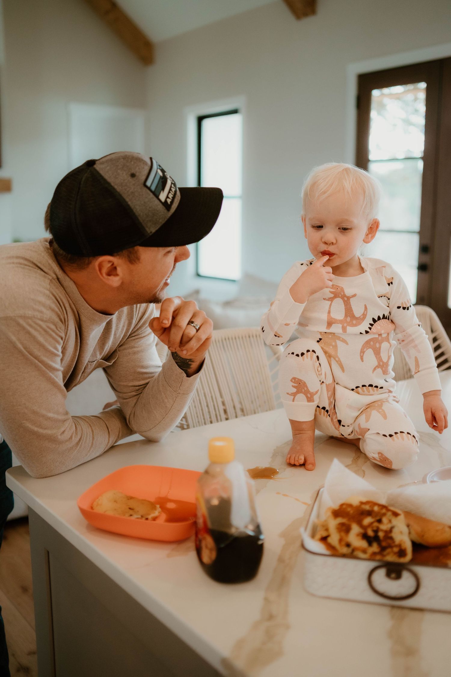 A heartwarming mealtime scene shows shared moments between parent and baby at a dining table.