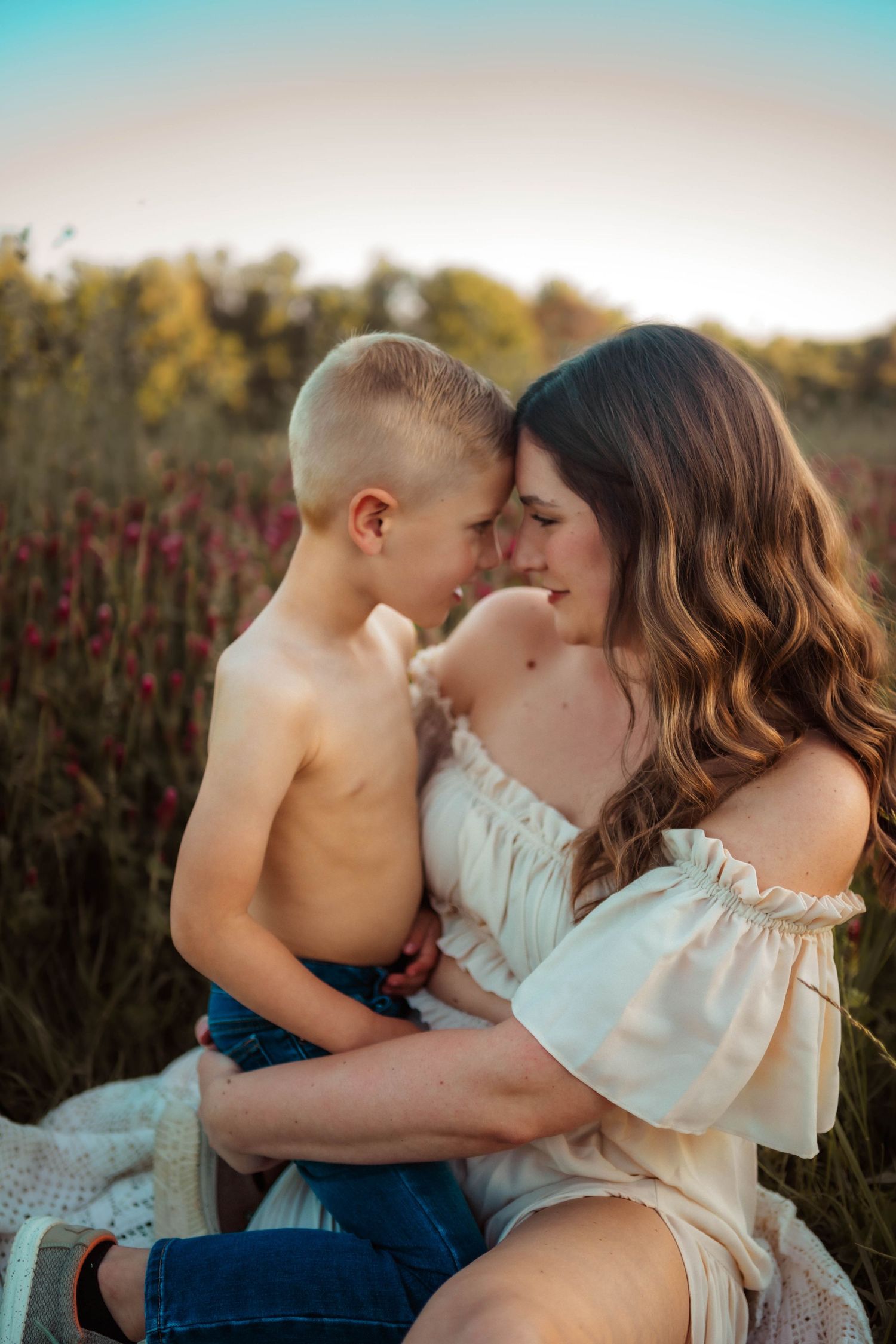 An intimate family portrait session in a wildflower meadow during sunset.