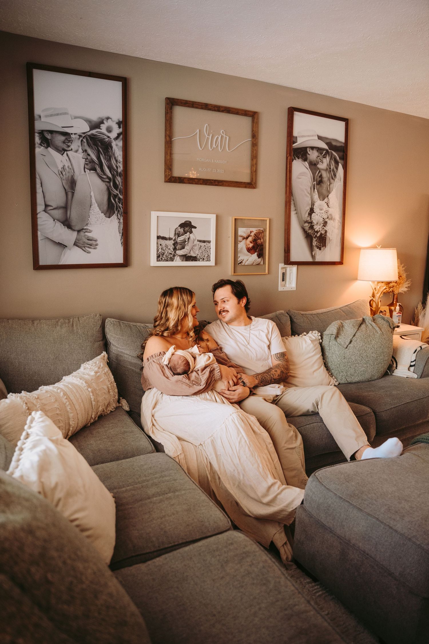 Family relaxing together on grey sectional couch in cozy living room.
