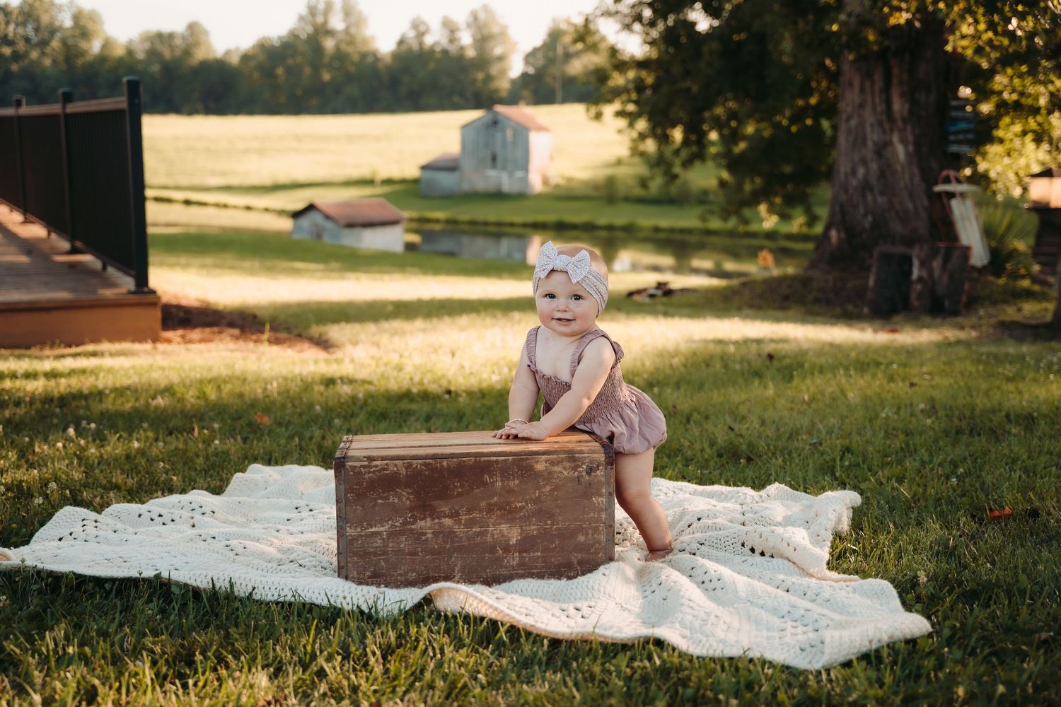 Vintage quilt laid out on grass during golden hour.