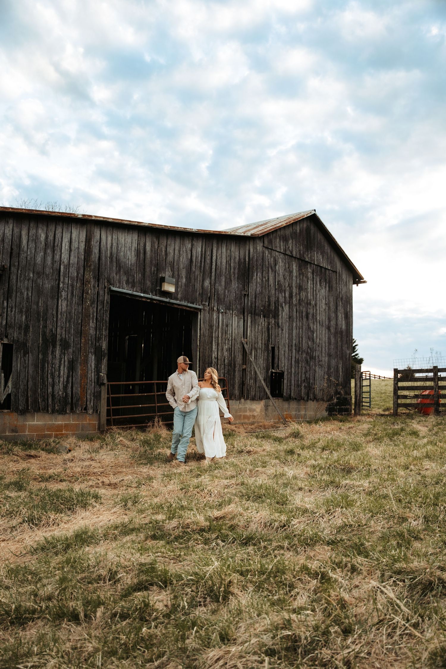 A weathered wooden barn creates dramatic backdrop for outdoor portraits.