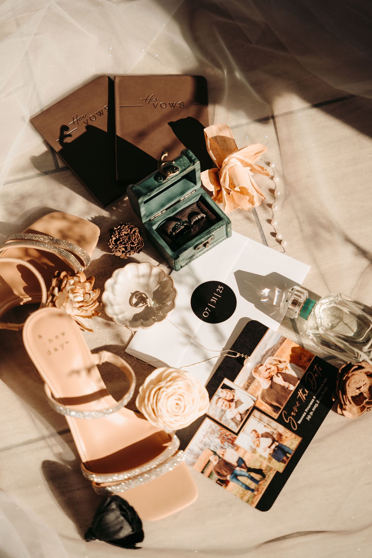 Wedding detail flatlay with vintage cameras and soft pink accessories.