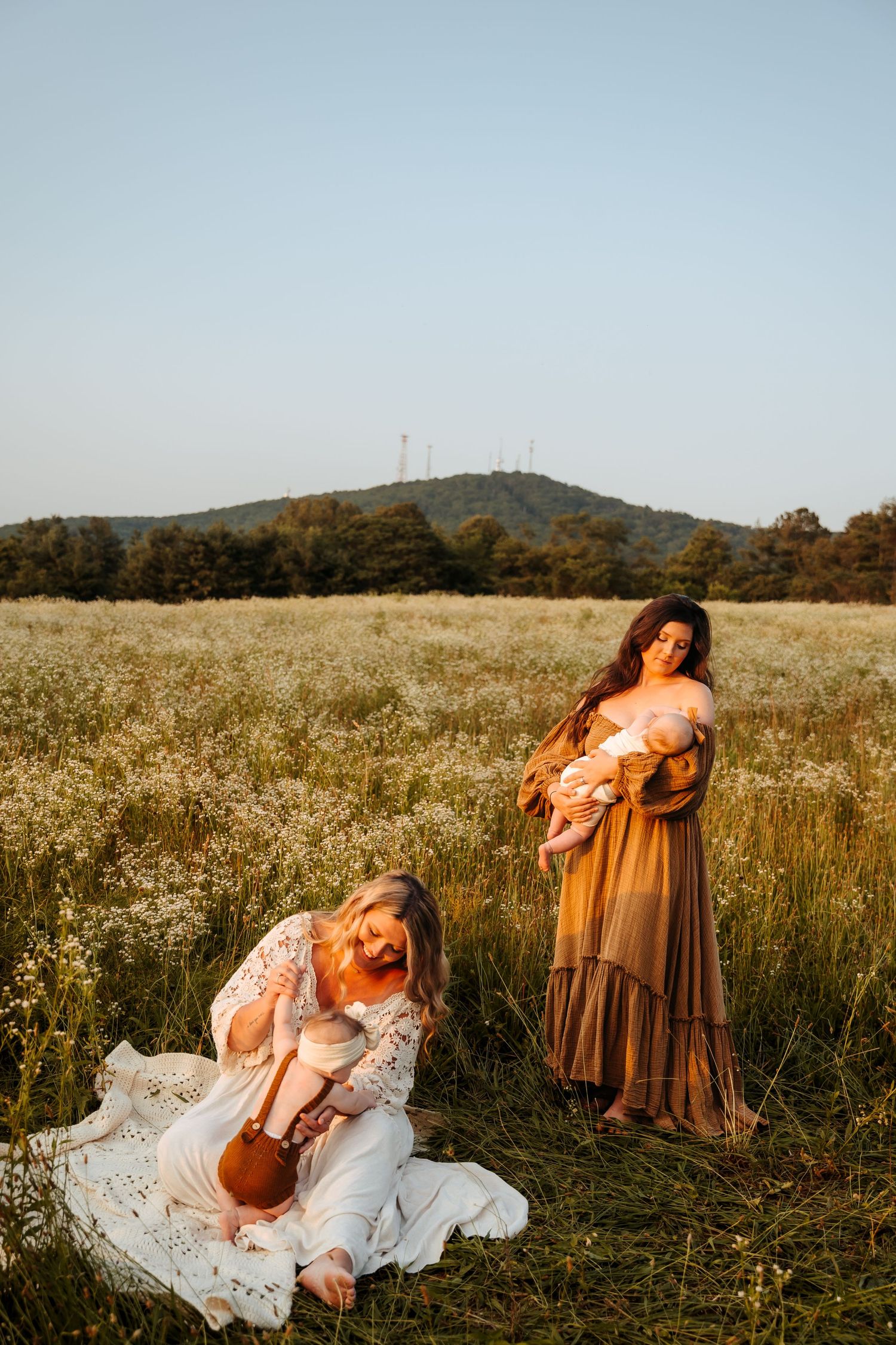 Dreamy sunset portrait session in a wildflower field with flowing dresses.