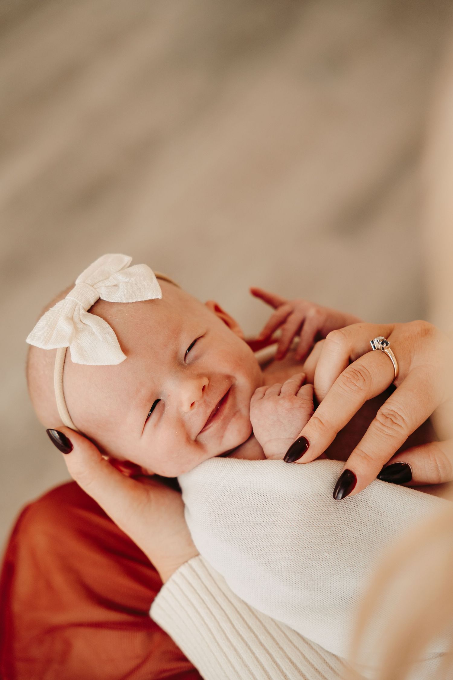 Tender close-up shots of sleeping newborn baby wrapped in white blanket.