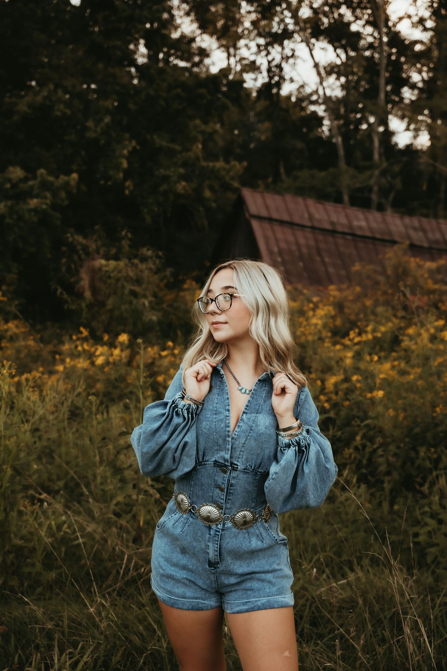 Casual denim outfit photoshoot in a field of wildflowers at golden hour.
