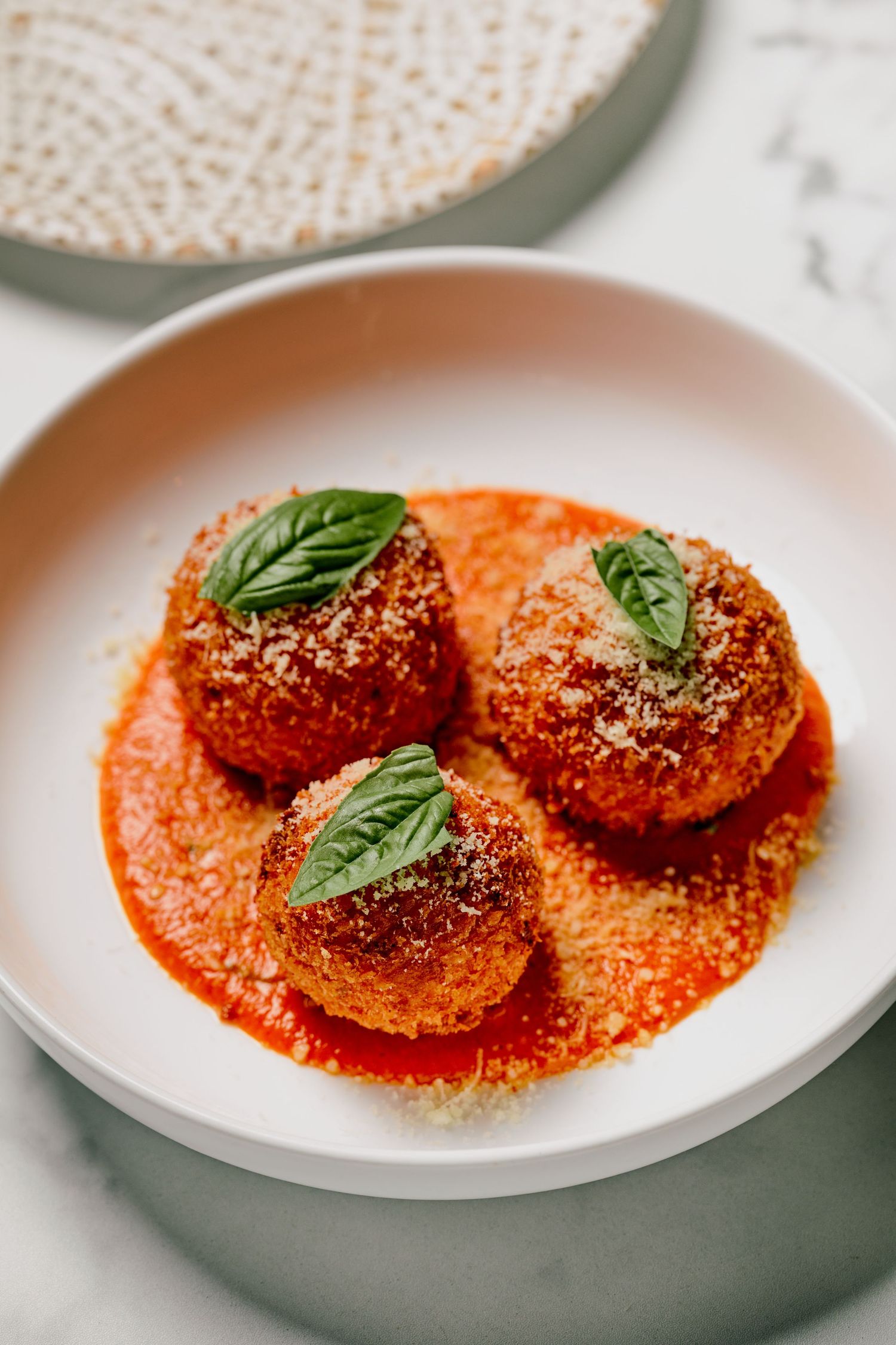 Spicy beef meatballs in harissa sauce with couscous and coriander