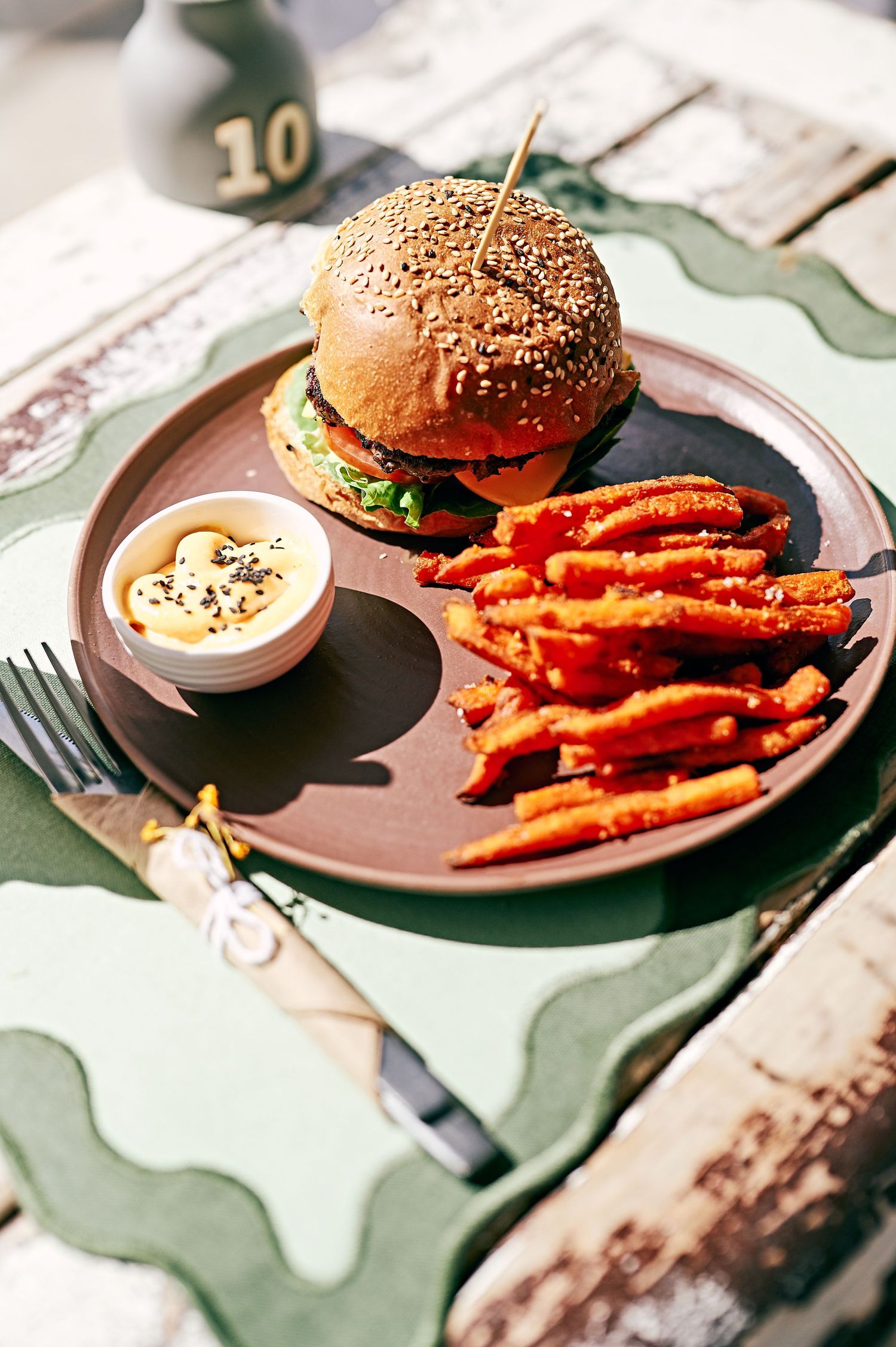 yummy burger on a  table in a cafe with fries