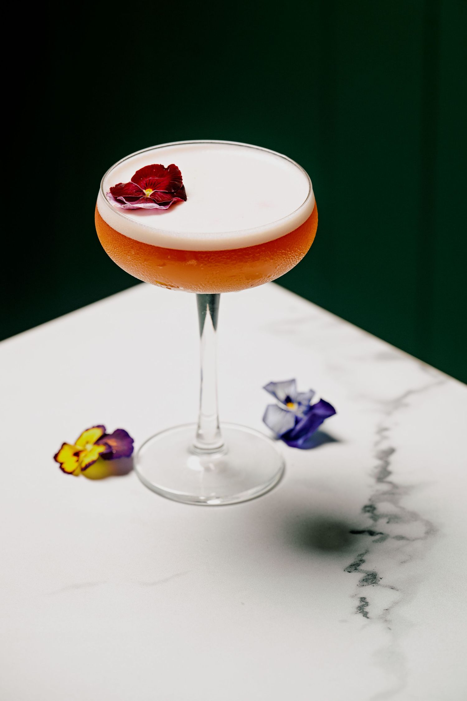 Peach flavoured cocktail with flowers.