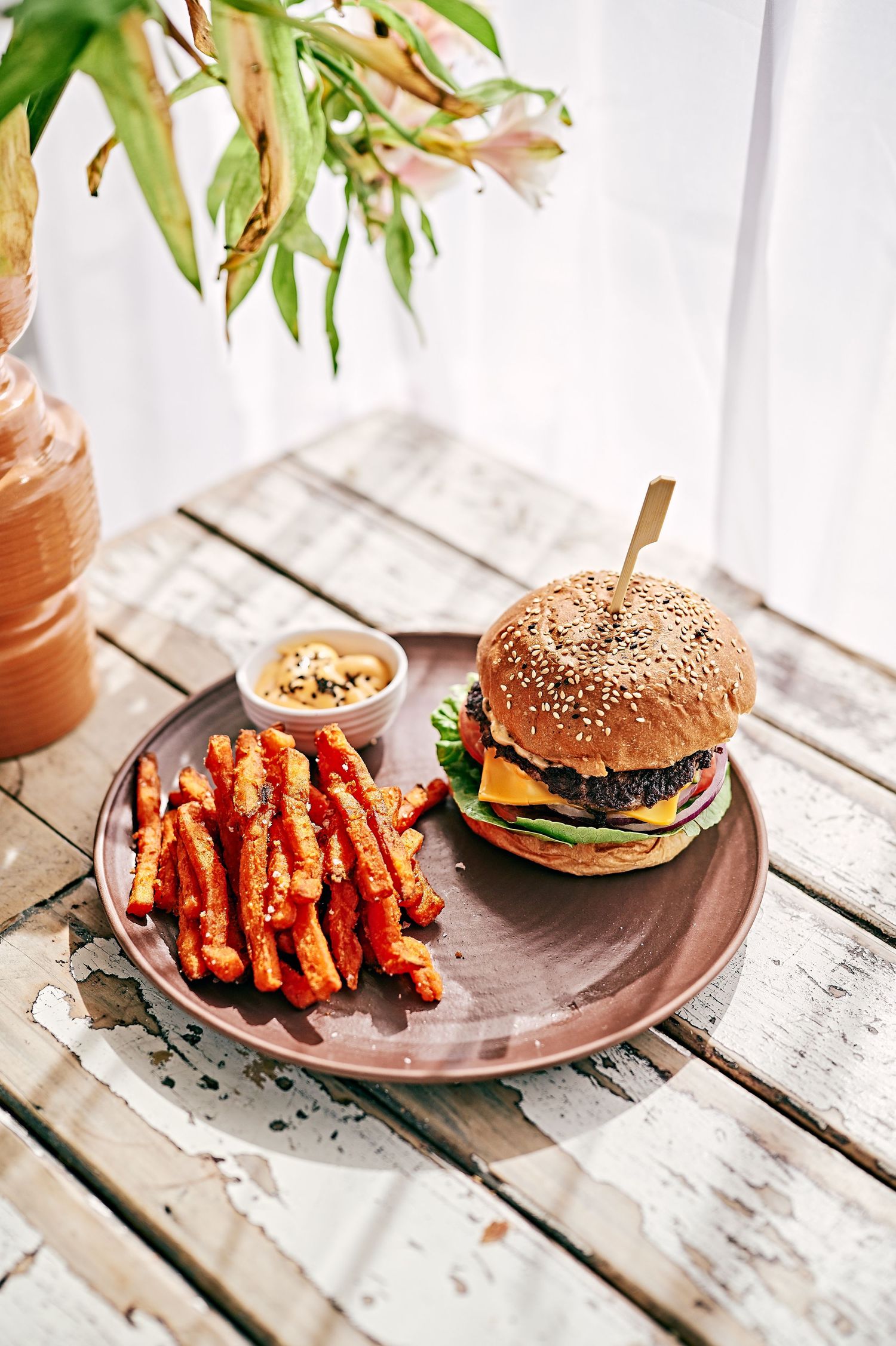 yummy burger on a  table in a cafe with fries
