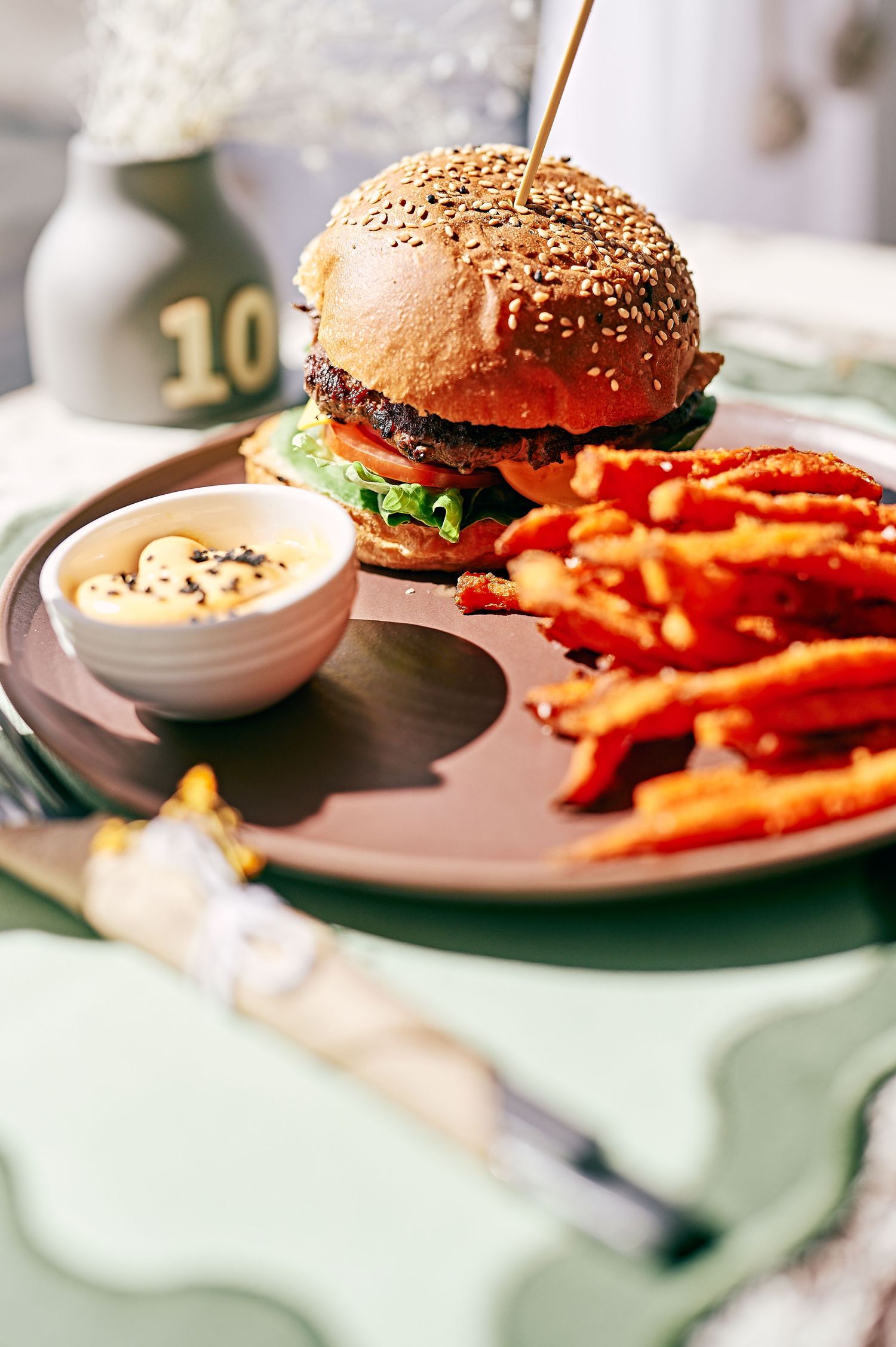 yummy burger on a  table in a cafe with fries