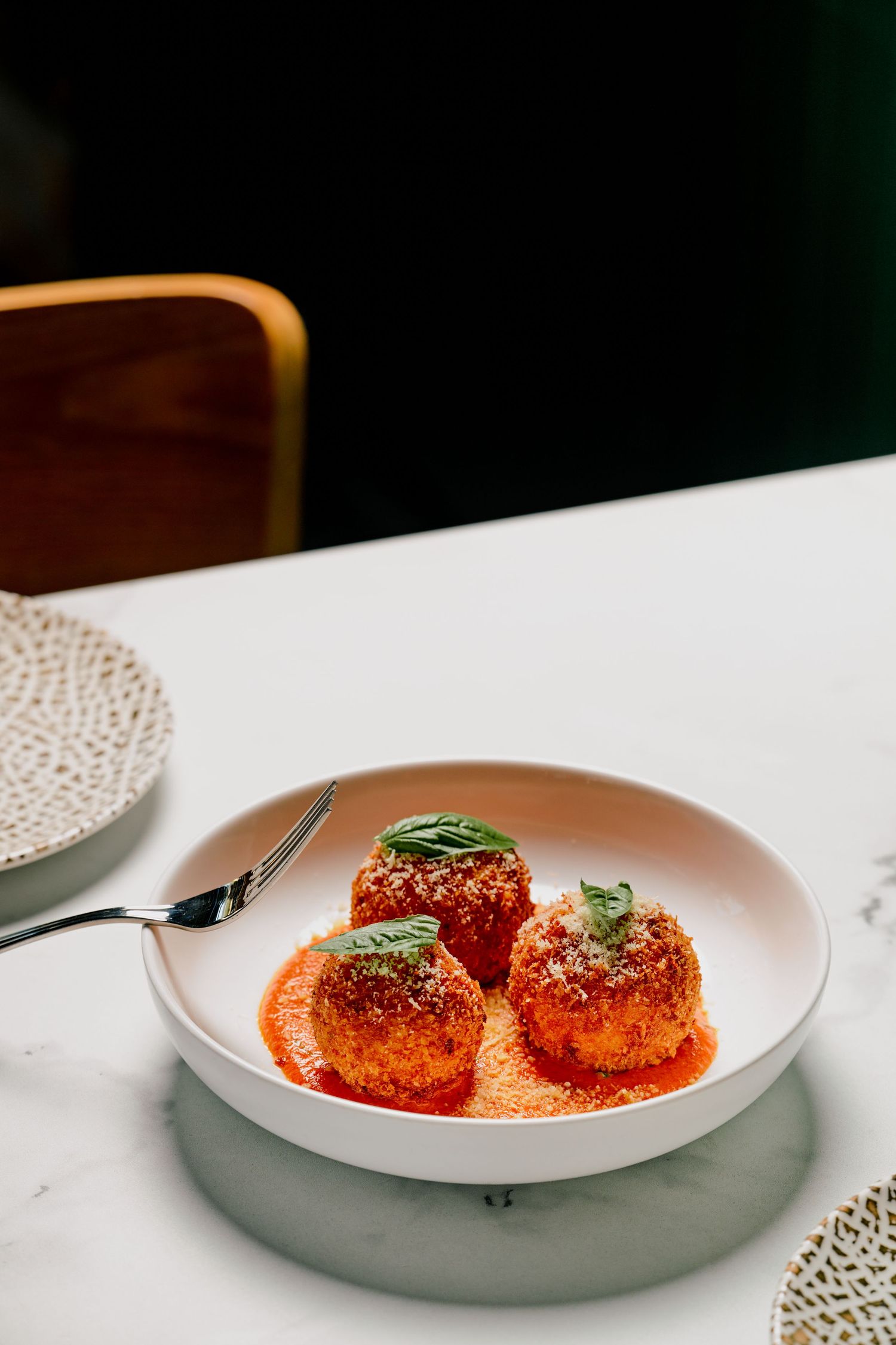 Spicy beef meatballs in harissa sauce with couscous and coriander