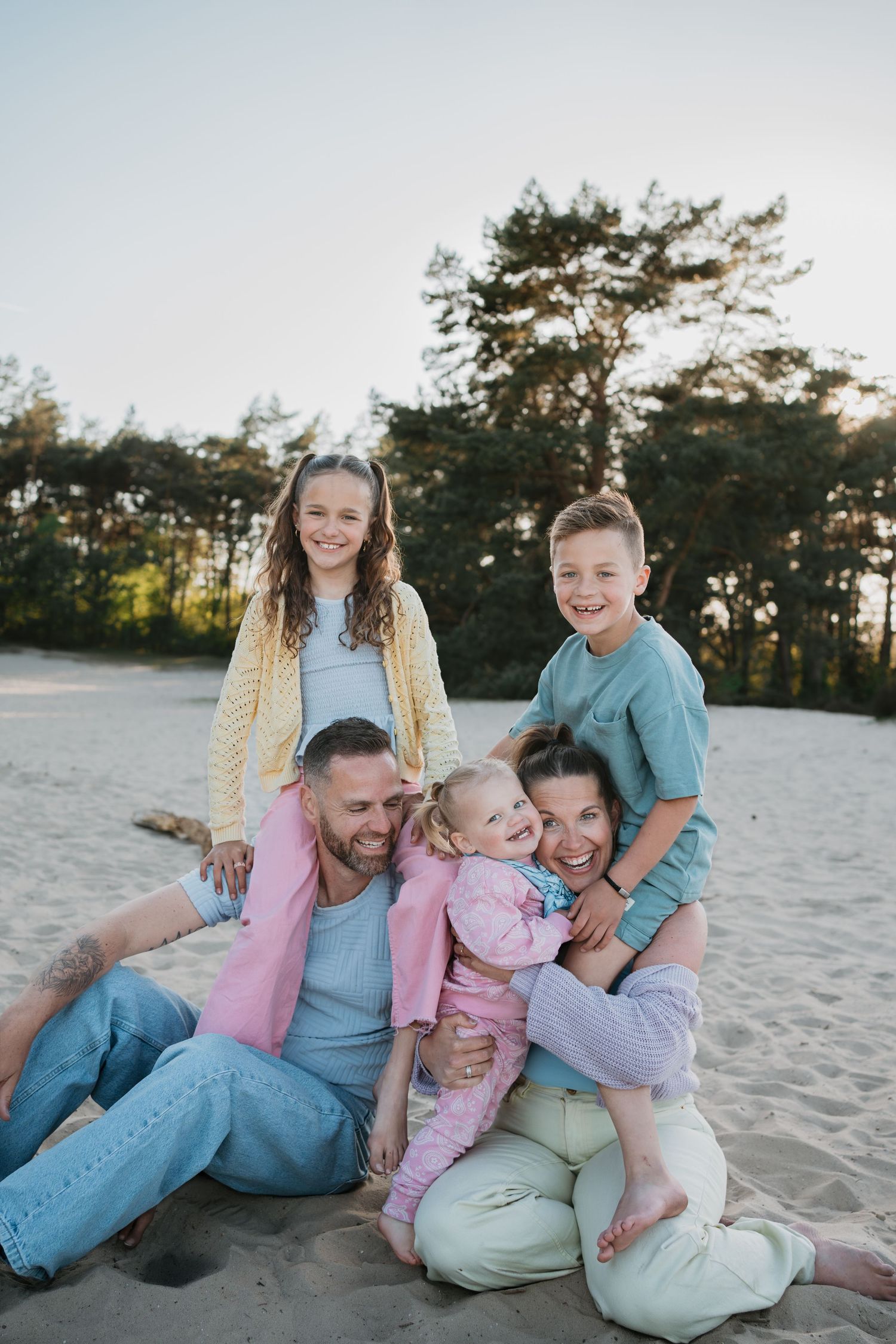 Gezinsshoot Soest: een lachend kleurrijk gezin met drie kinderen tijdens een spontane fotoshoot in de Soester Duinen.