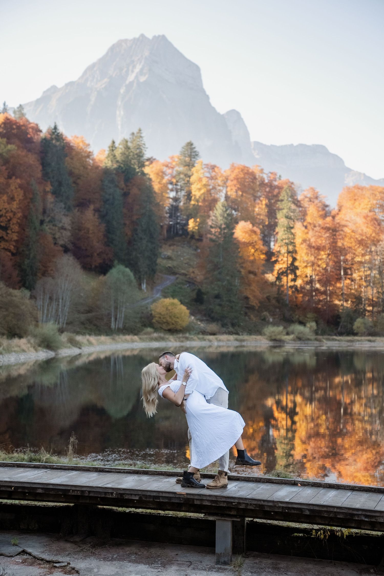 Paar vor einem Bergsee. Herbstmoment und goldene Farben.