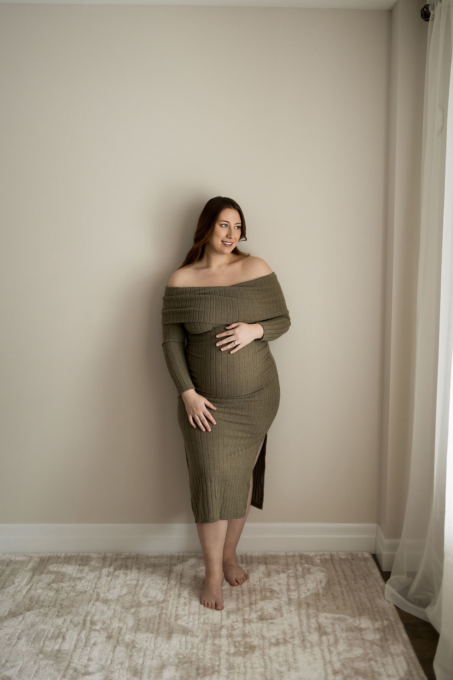 Maternity photo series showing four poses in an off-shoulder olive dress against a neutral wall and light carpet.
