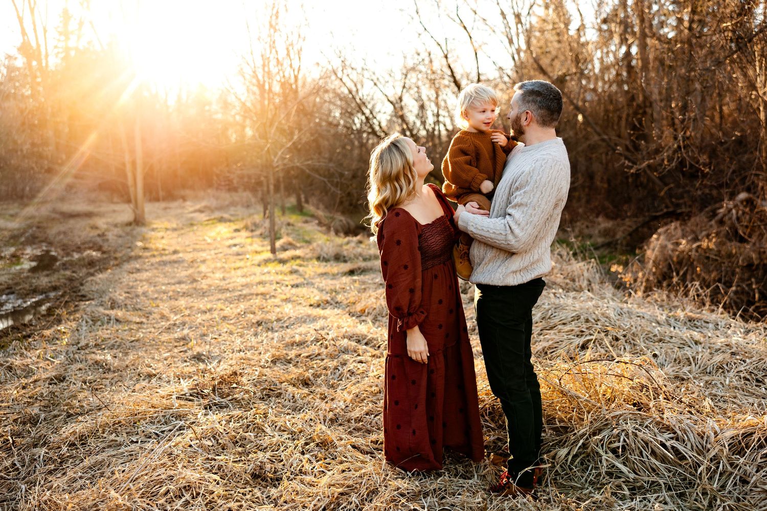 A romantic sunset moment in a field with warm golden light filtering through.
