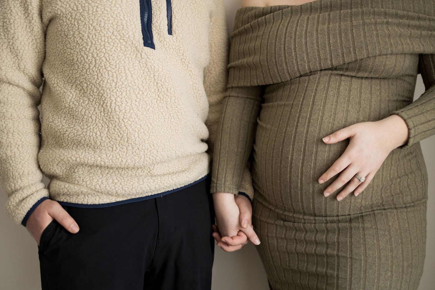 A person wearing a beige sweater and brown pinstripe pants shows different angles of their outfit.