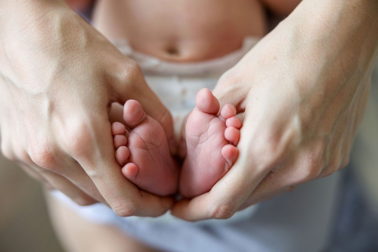 Close-up sequence showing two hands coming together and interlocking fingers in different positions.
