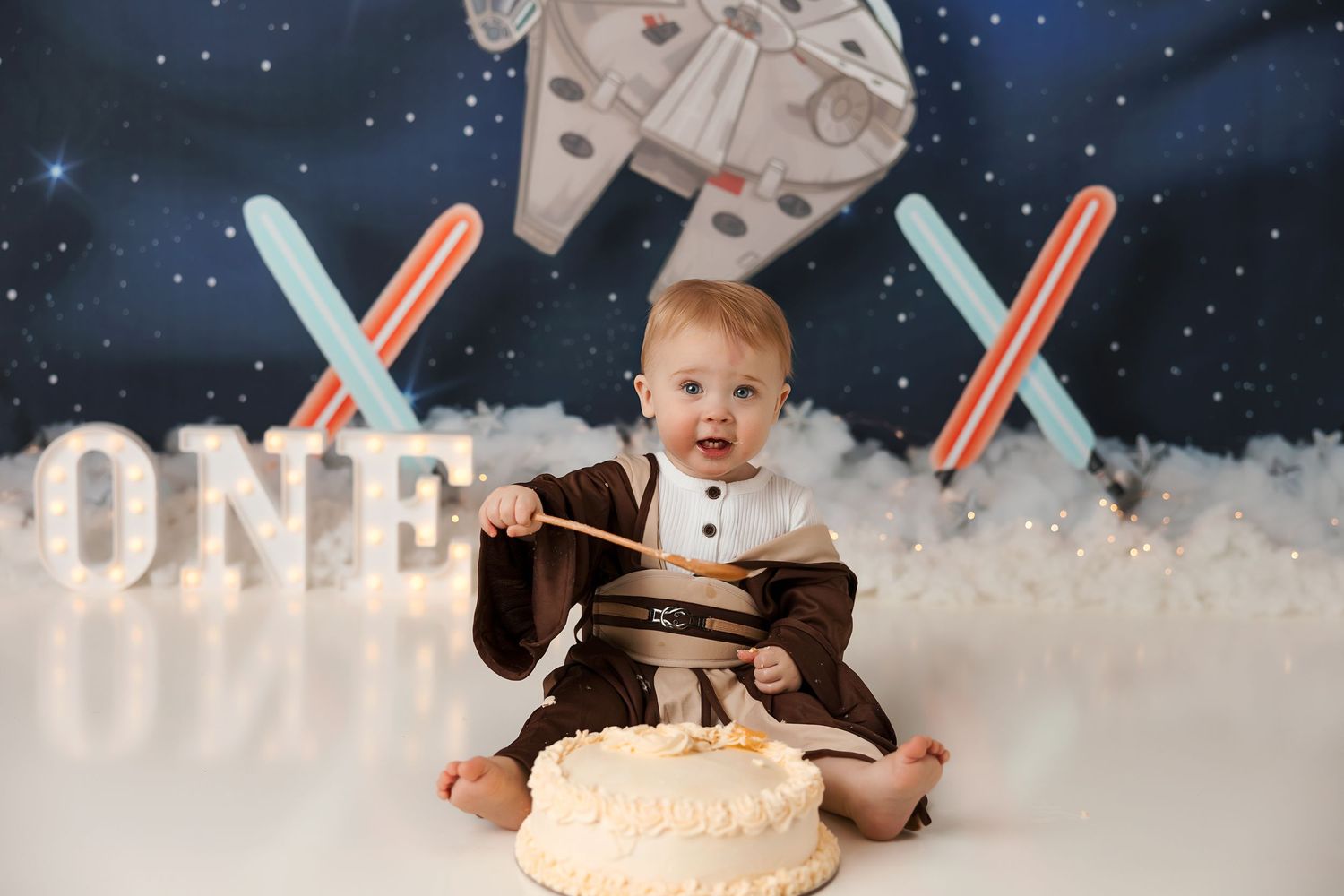 Star Wars themed party setup with lightsabers and galaxy backdrop.