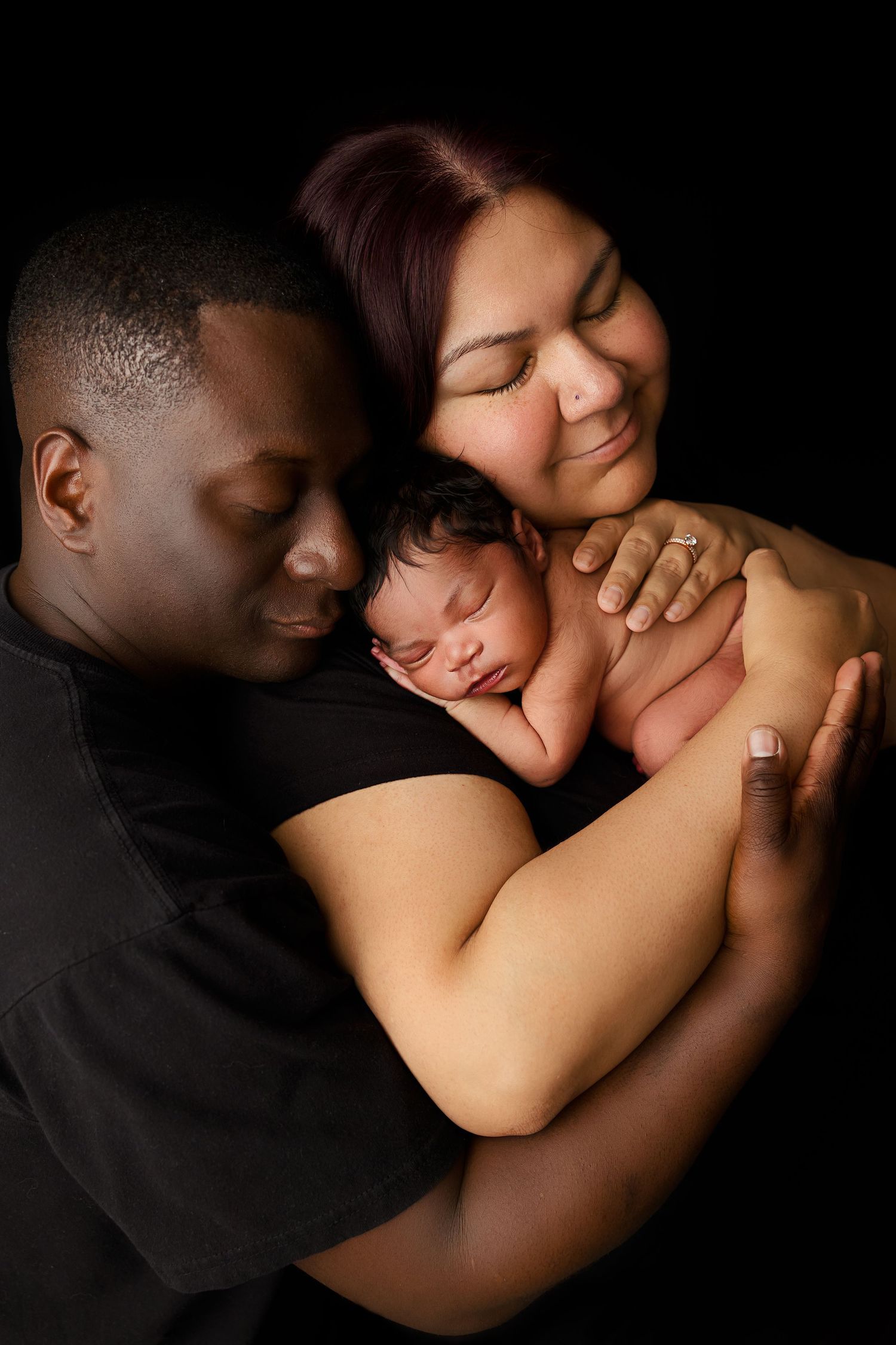 Intimate black and white photo series showing tender moments of affection between a couple in dim lighting.
