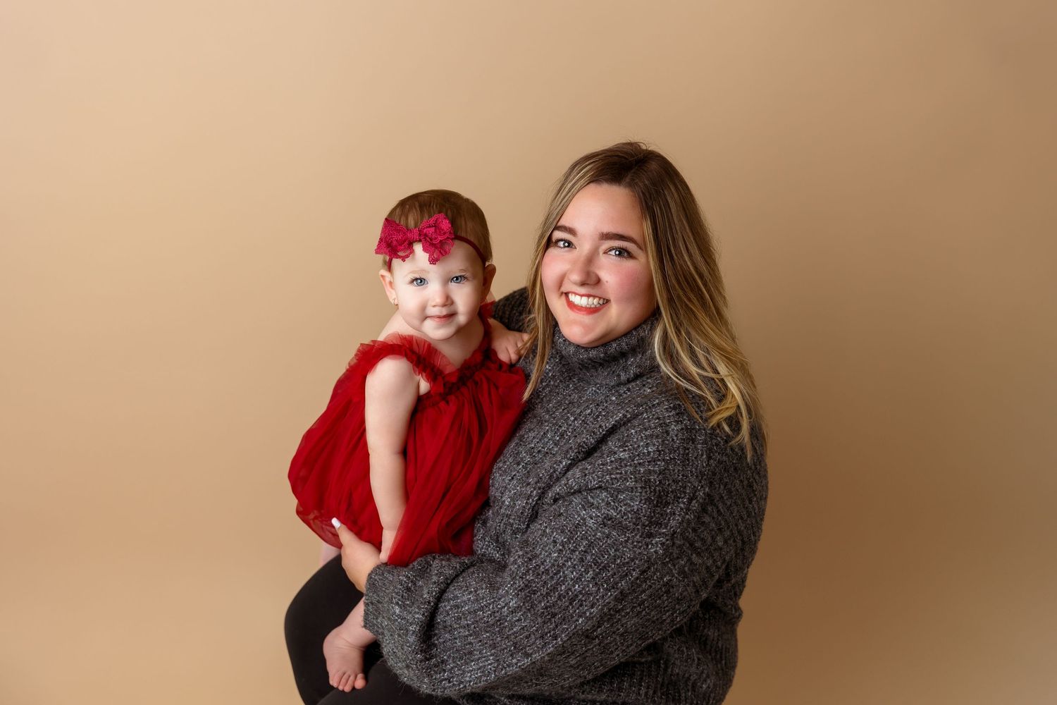 Studio portrait against beige background with winter outfits.
