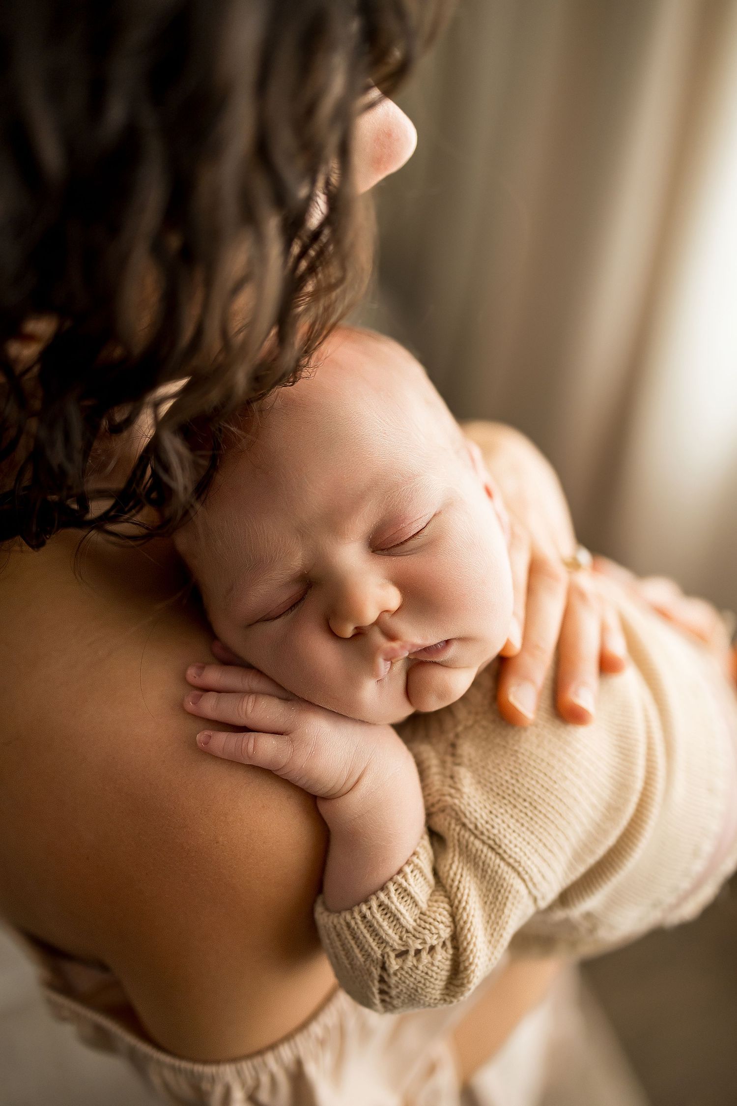 A close-up series of tender newborn photos showing tiny fingers and soft skin in warm natural lighting.