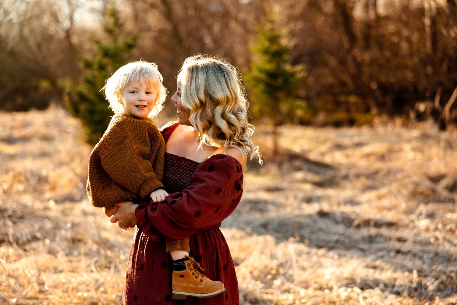 Tender moment between family members in warm autumn sunlight.