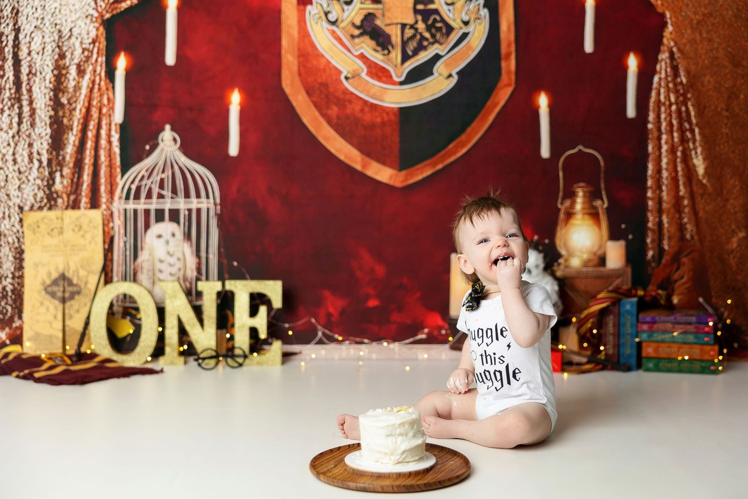 Harry Potter themed first birthday setup with Hogwarts banners and magical decor.