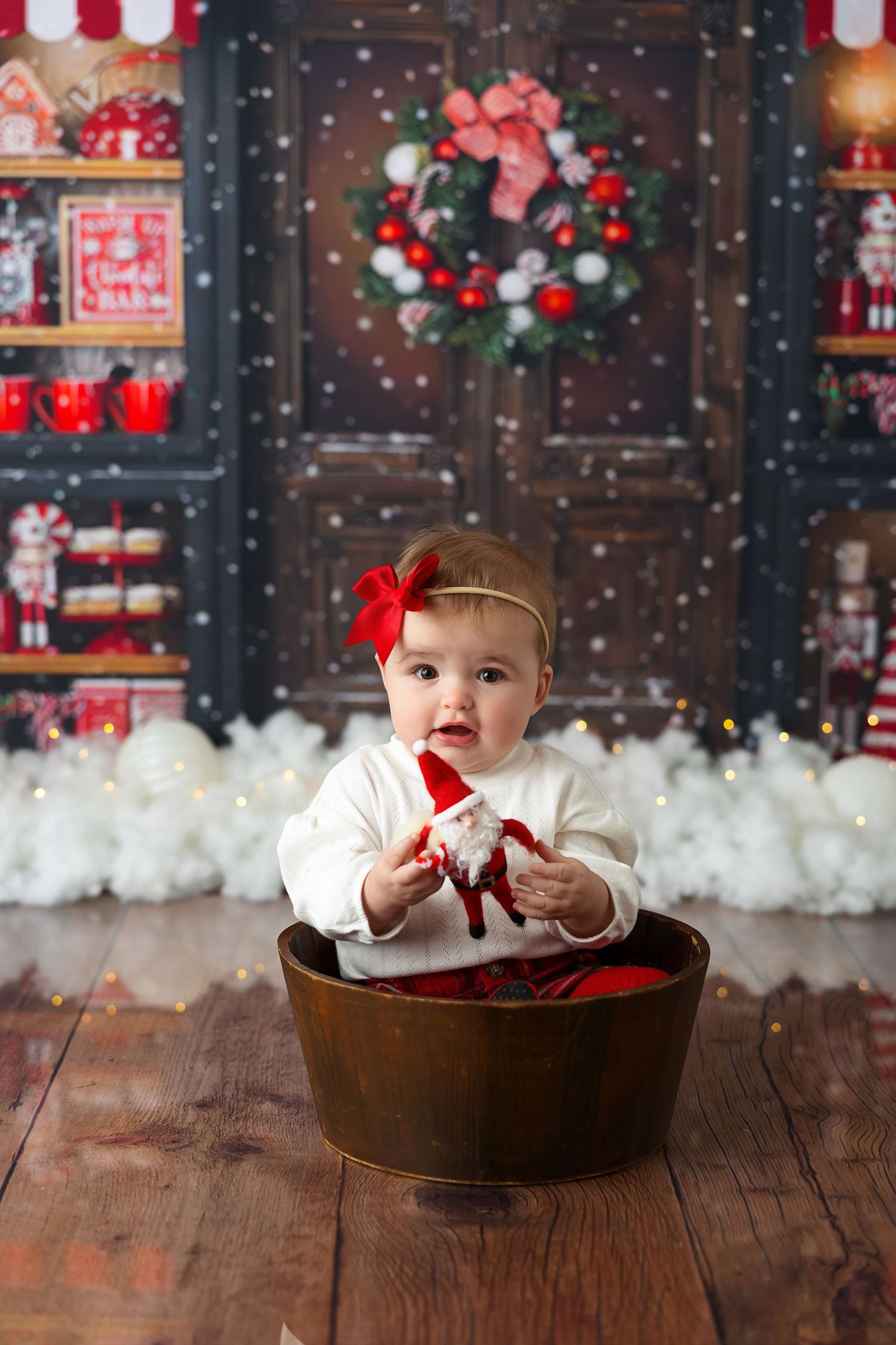 Festive holiday scene with a wooden washtub against a Christmas backdrop with wreath and decorations.
